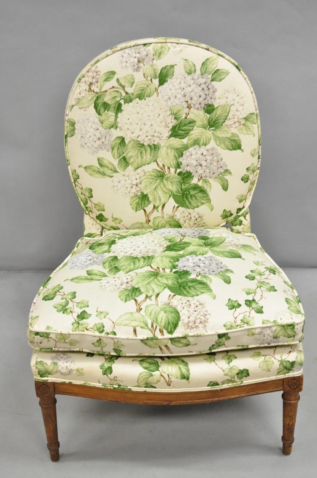 Antique French Country Louis XVI Style Carved Walnut Boudoir Slipper Lounge Chair with Floral Print Upholstery. Circa Early 20th Century. Measurements: 34