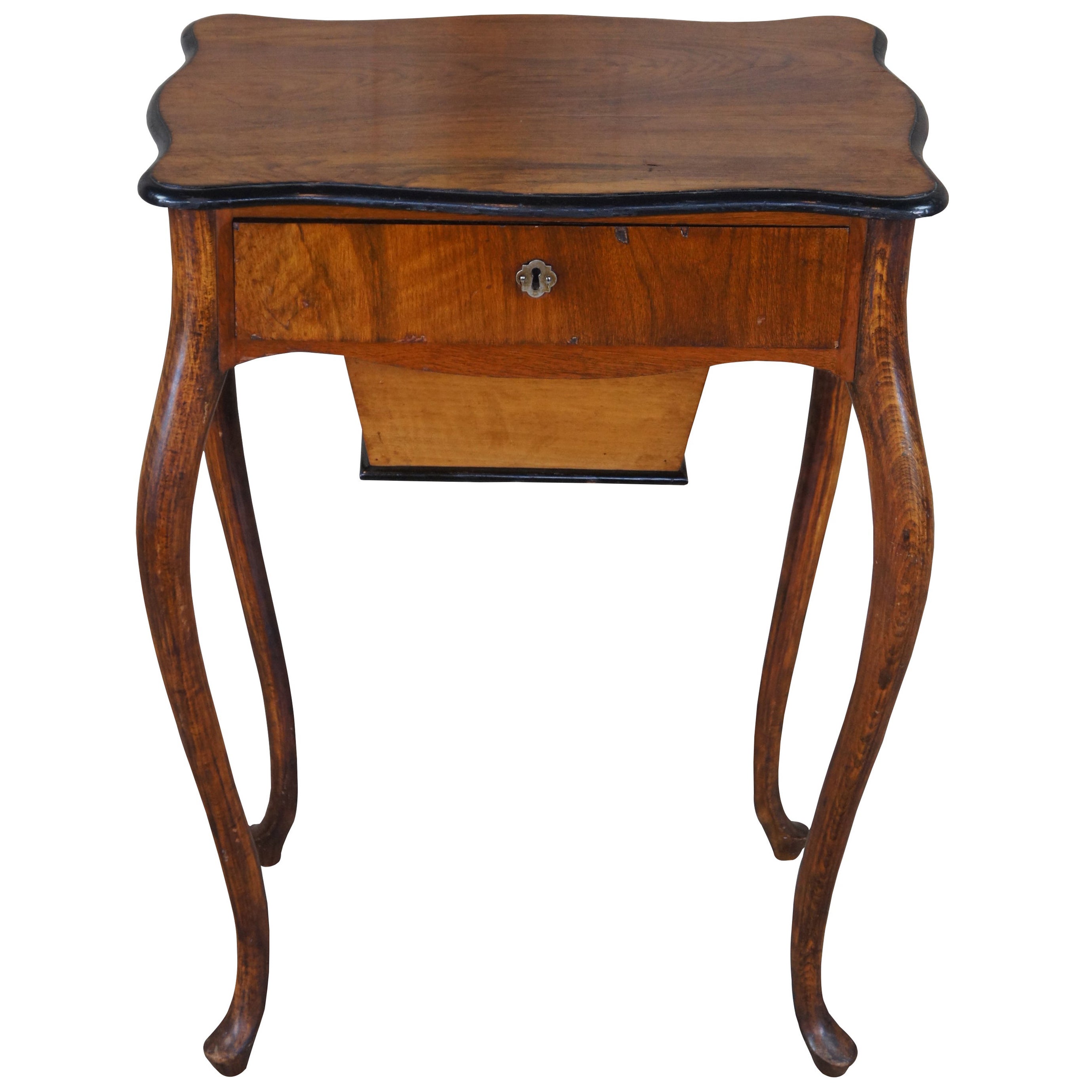 Antique sewing box table or cabinet, circa 1910s. Made from oak & walnut featuring serpentine form with upper drawer and lower box.
 