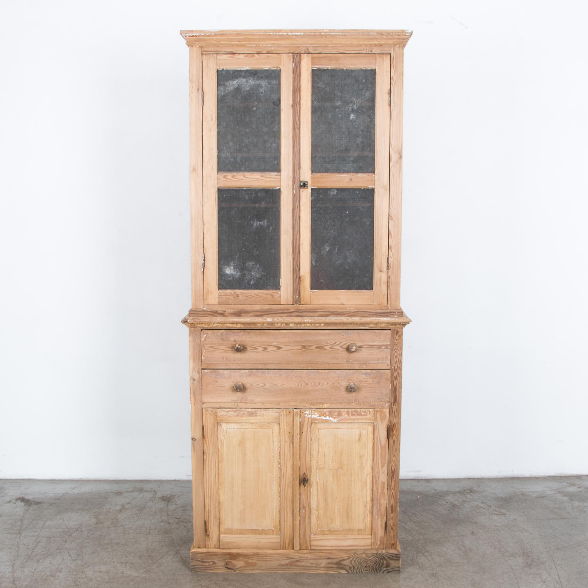 From France circa 1900, a tall cabinet with mesh covered upper doors. Originally used as a storage for dry goods and kitchenware, a perforated metal mesh protected the pantry contents. Distinctive period design is highlighted by the unique finish, a