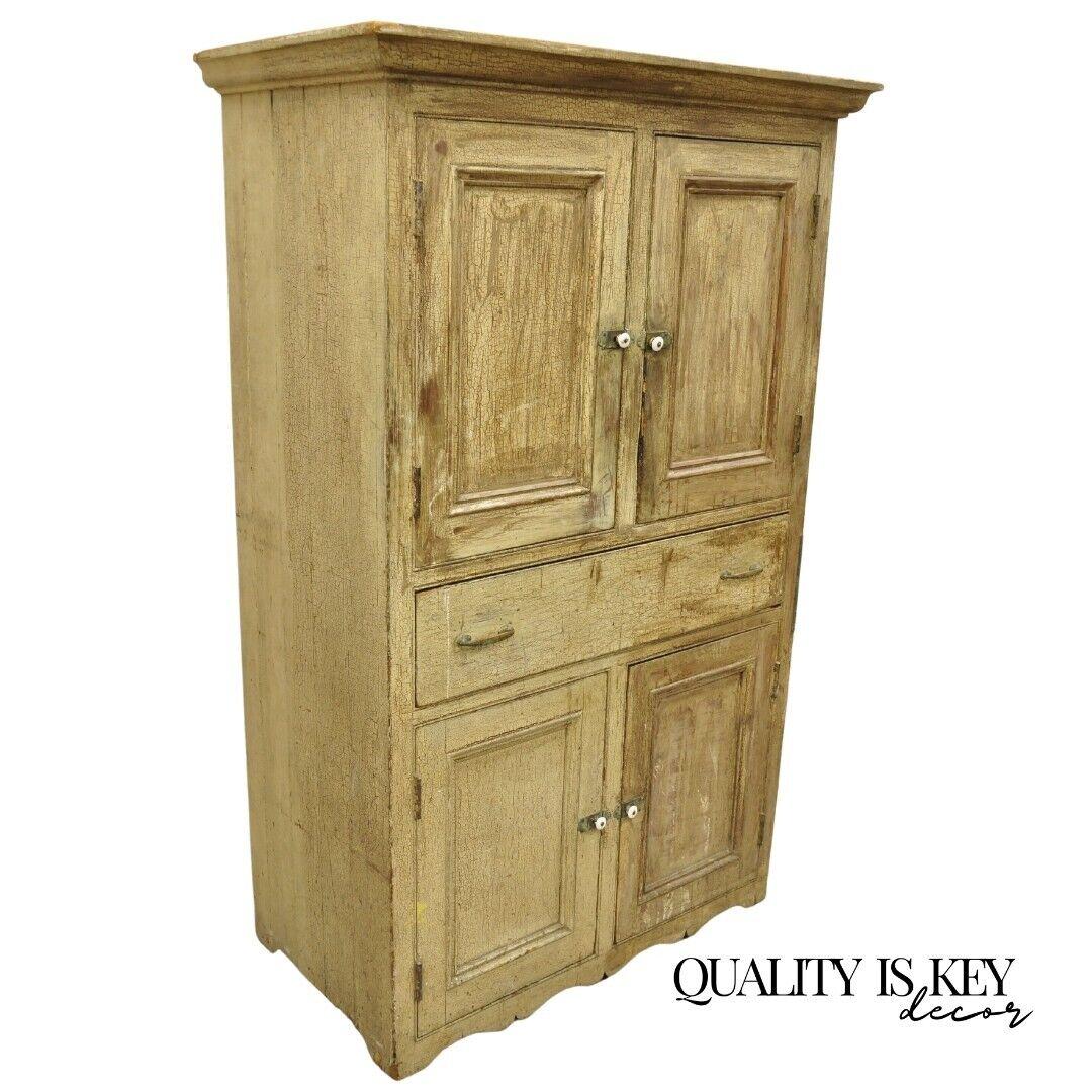 Antique French Country Primitive Beige Distressed Painted Cupboard Hutch Cabinet. Item features Antique alligatored distressed beige/cream painted finish, four swing doors, one dovetailed drawer, solid brass hardware, two wooden upper shelves, very