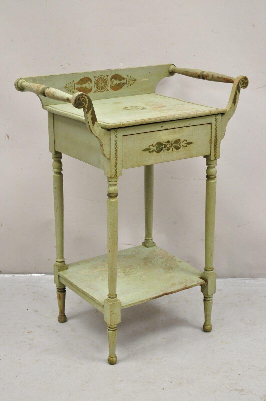 Antique French Country Primitive Green Painted Hitchcock Style Washstand Commode. Item features one dovetailed drawer, green distressed painted finish, stencil painted details, lower shelf, very nice antique item. Circa Early 1900s. Measurements: