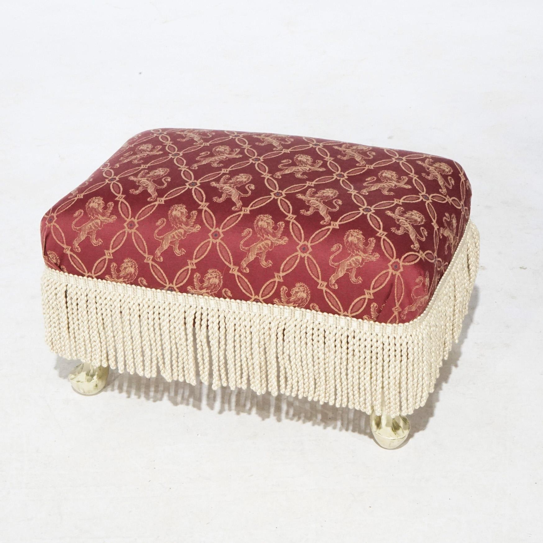An antique French Country style footstool offers upholstered seat with near-floor length fringe surround and raised on foliate carved and painted legs, circa 1920.

Measures- 12.5''H x 21.5''W x 15''D.