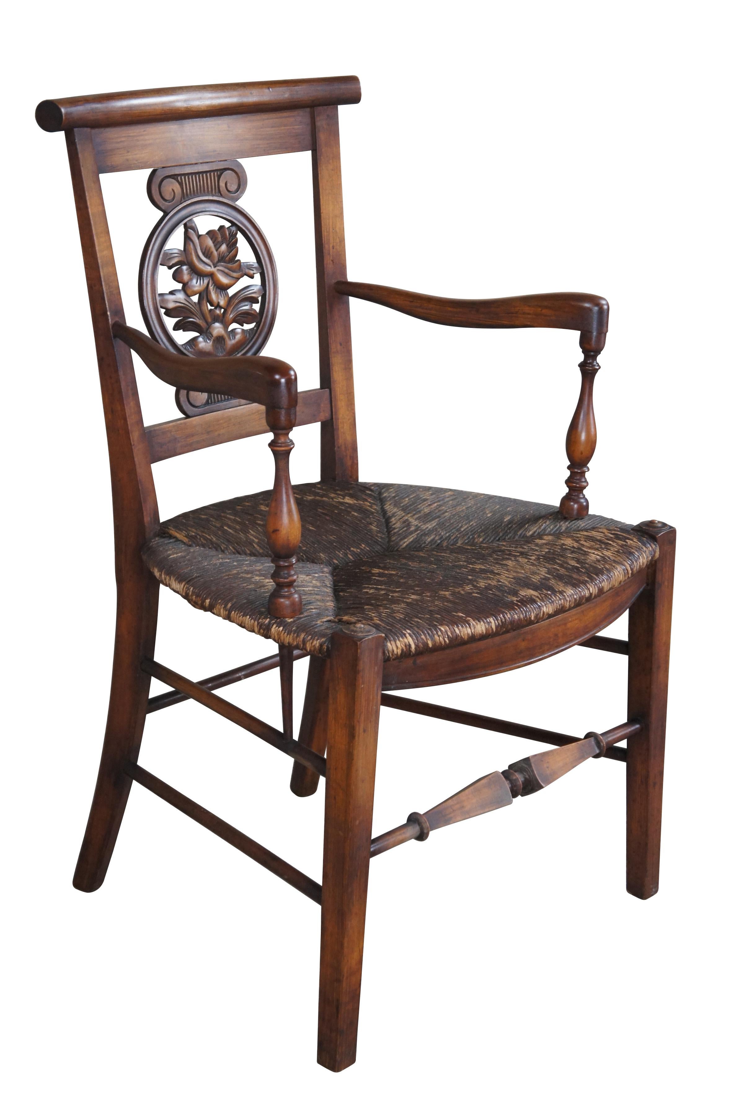Antique Country French Arm Chair.  Made from walnut with a round botanical carved splat back set between Grecian style capitals.  Features turned arm supports and a unique square tapered stretcher along the front.

Dimensions:
21