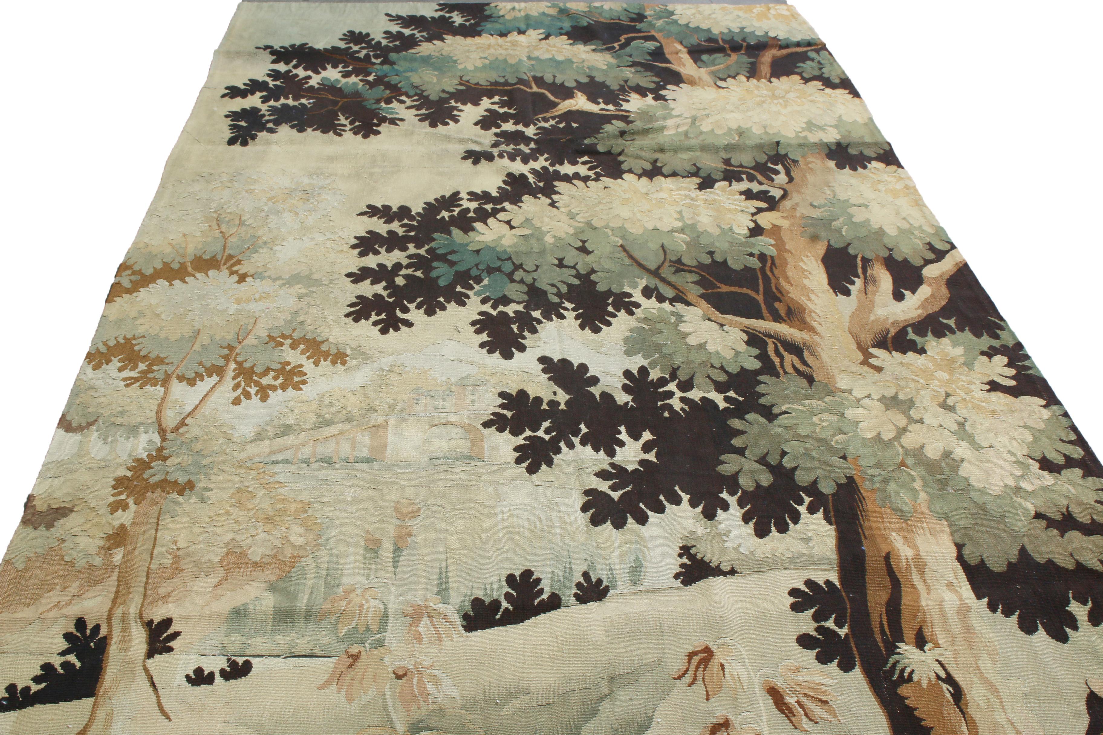 Originating from France between 1900-1910, this traditional antique French tapestry is handmade with a fine wool body, depicting a uniquely stylized, borderless forest scene beside a river. Enjoying a more advanced take on the hyper-realistic scenes