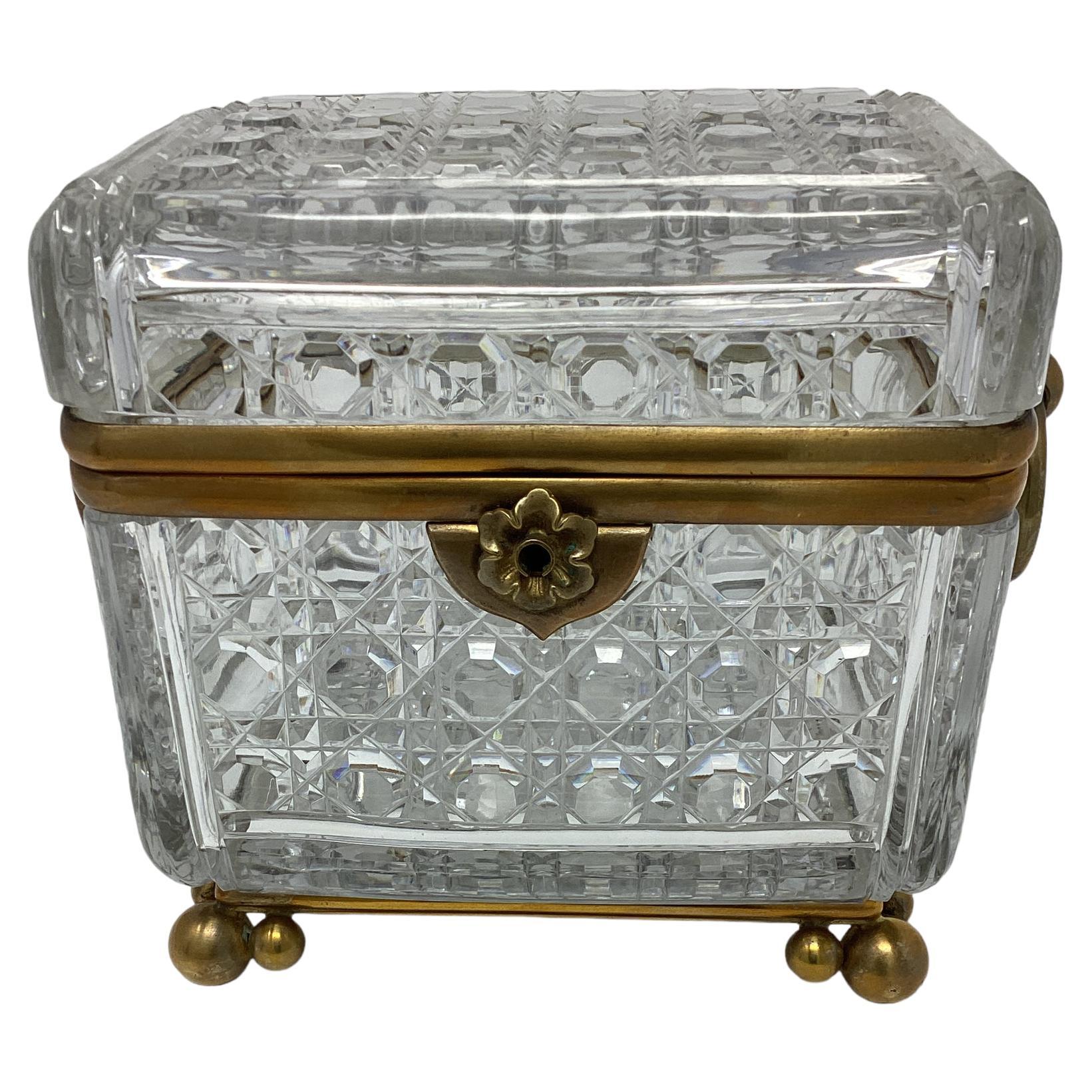 Antique French Crystal Box with Ring Handles. Heavy cut crystal in a diamond shaped design. The box sits on top of 3 round ball feet.