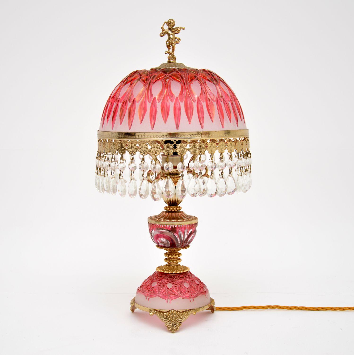 A stunning antique cut crystal glass table lamp dating from around the 1950’s period, which was made in France.

It is beautifully made, with gorgeous colours and patterns in the glass. There are also incredibly fine and detailed gilt metal