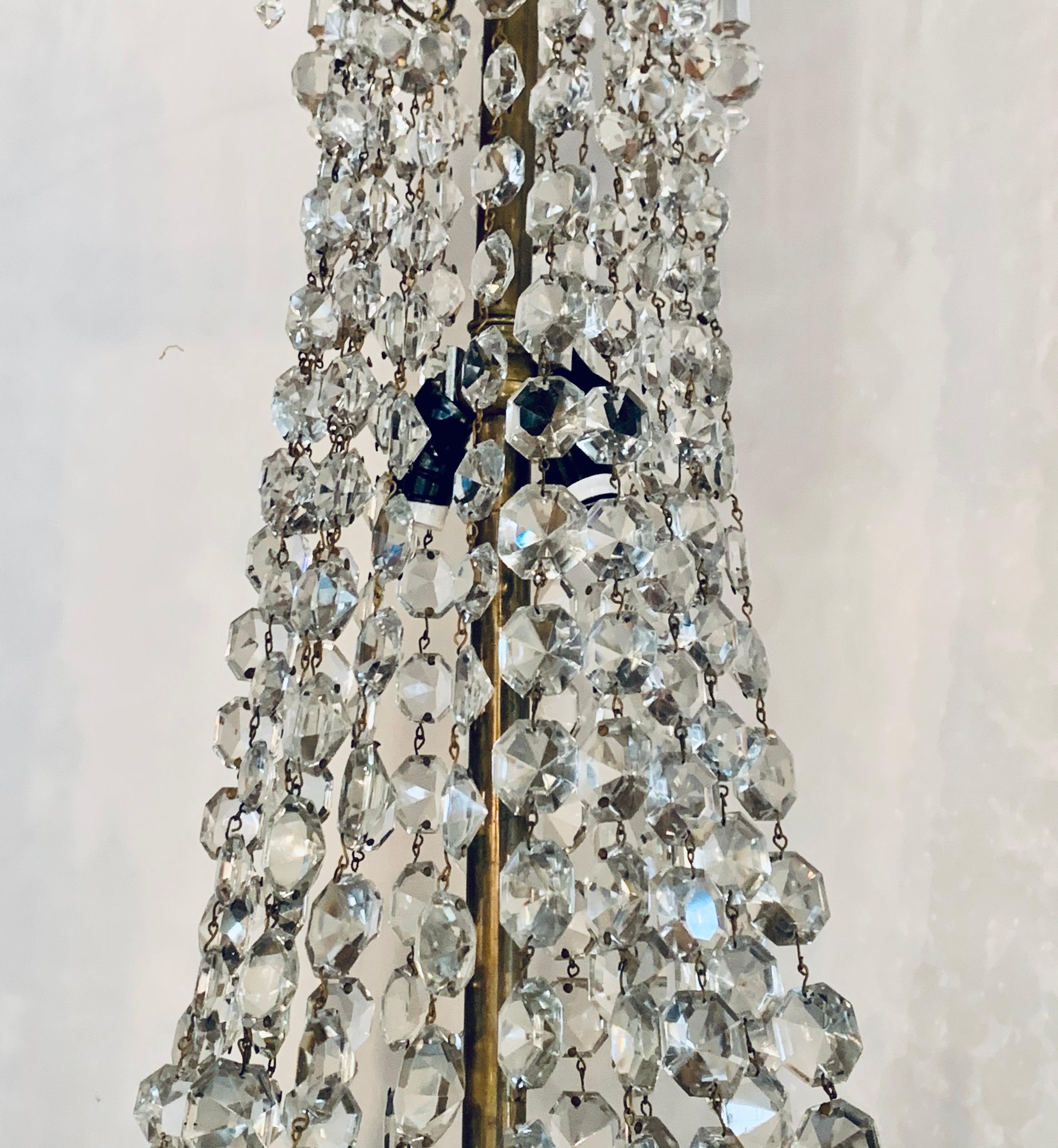 Antique 1920's French crystal and bronze cascading basket-form chandelier with an embossed bronze band with applied wreaths and ribbon detail all around. Top has long crystal prisms. There are 3 lights inside basket and 2 lites behind cascading.