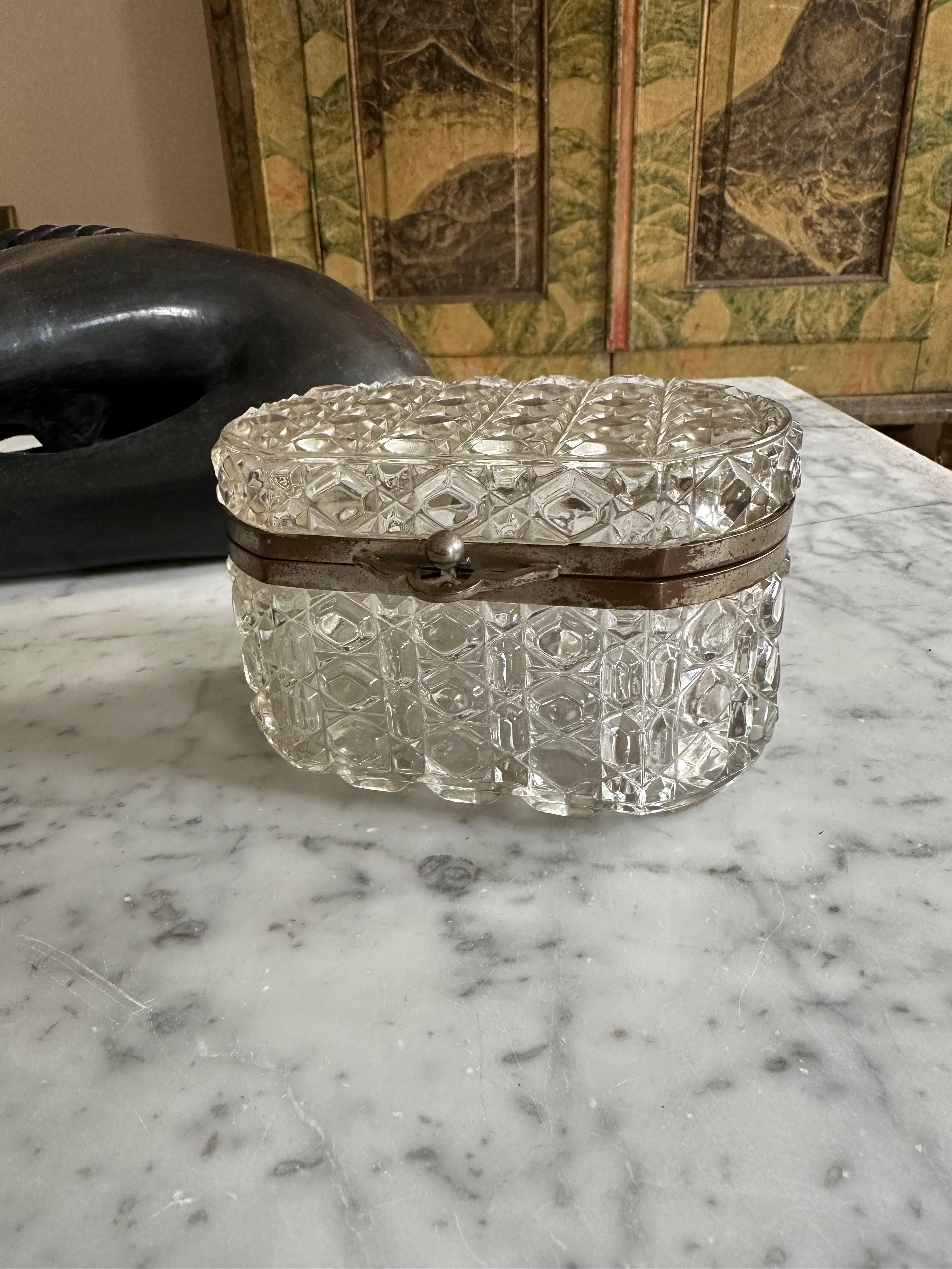 
Add a touch of elegance to your decor with this exquisite antique French pressed Glass jewelry box. Crafted in the early 1950s, this small crystal box is a perfect blend of functionality and sophistication, making it a versatile piece for any