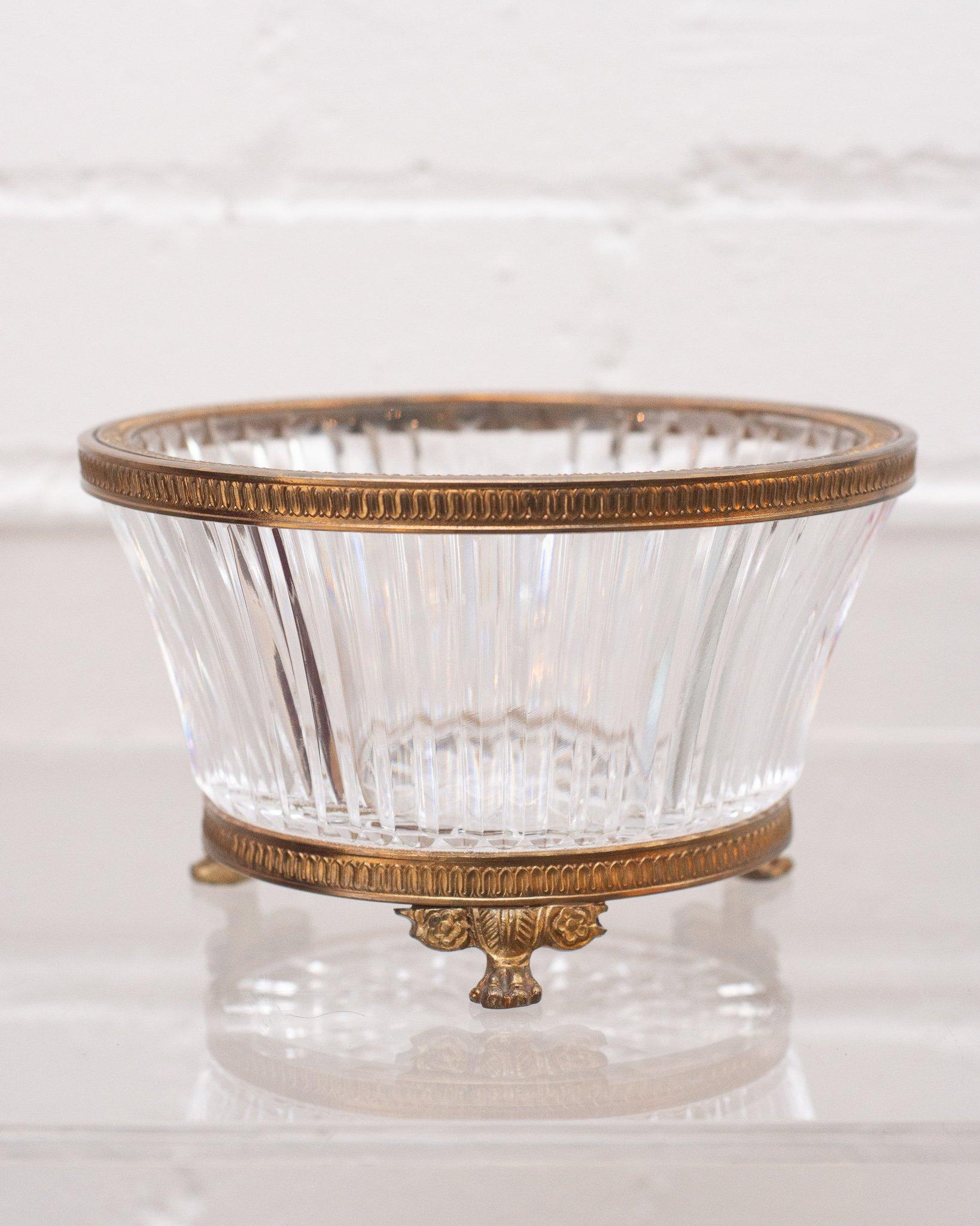 An ornate clear cut crystal dish circa 1890, with bronze mount. This elaborate handcut crystal catches the light beautifully.