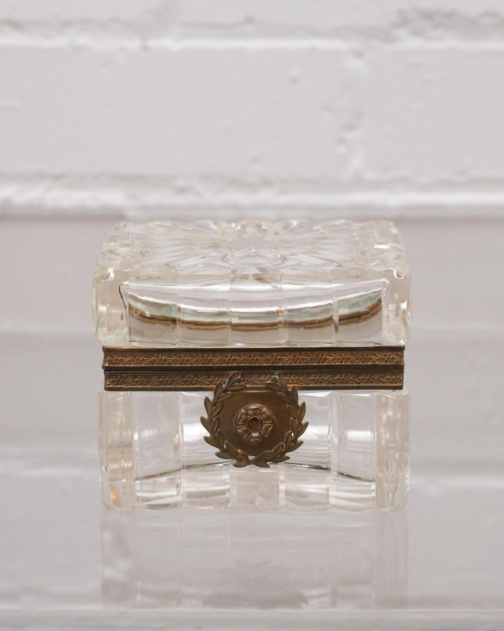 This antique crystal and bronze box makes a statement in any space. An early 1900s French production, this piece transitions from modern to classic interiors seamlessly with its sophisticated shape and light catching quality.