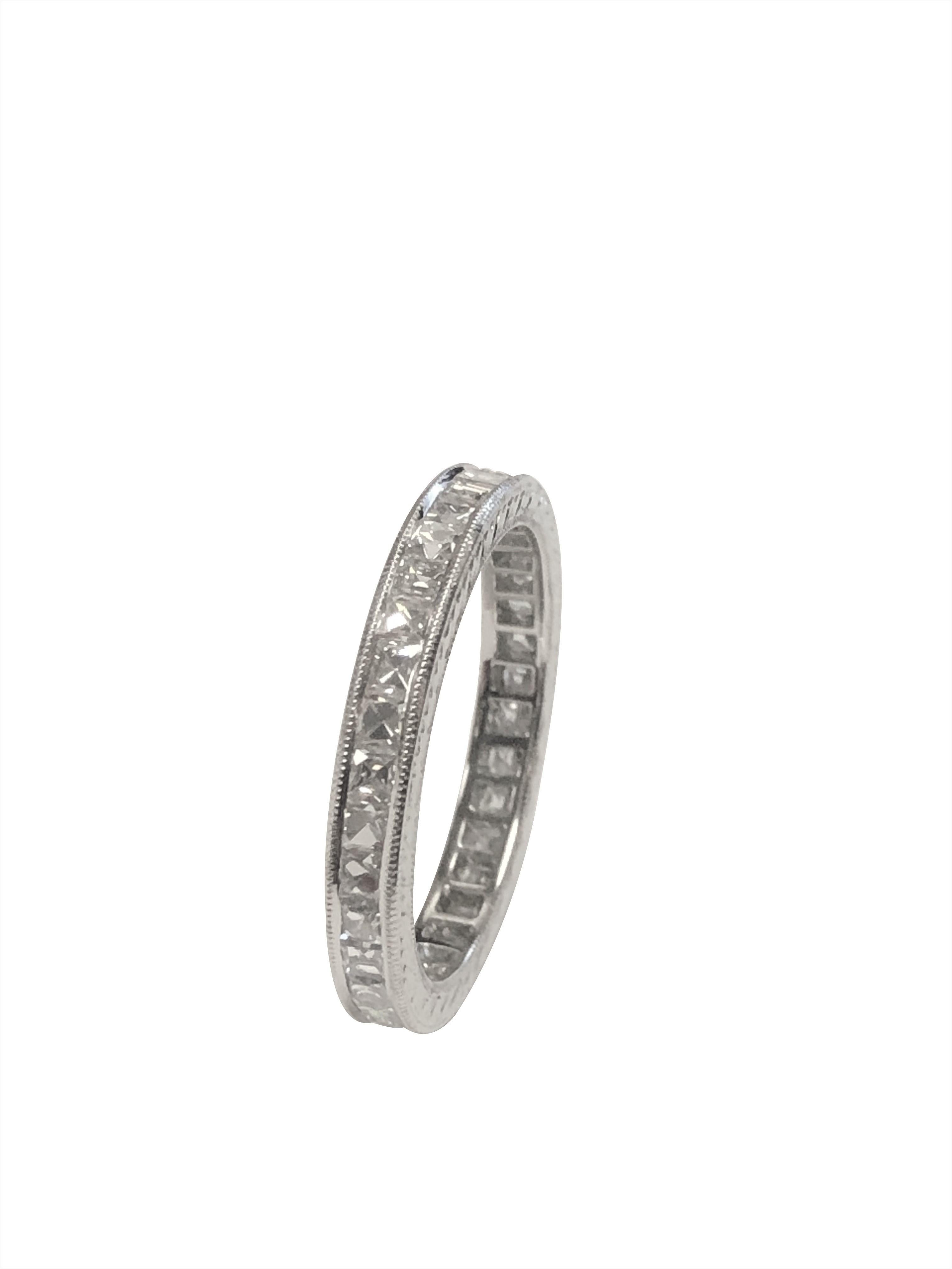 Circa 1920s Platinum Eternity Band Ring, measuring 2.5 M.M. wide and is a finger size 6, set with French Cut Diamonds totaling 1.25 Carats. The Ring was recently restored including resetting of the channel, re Milgrain and re engraving the design
