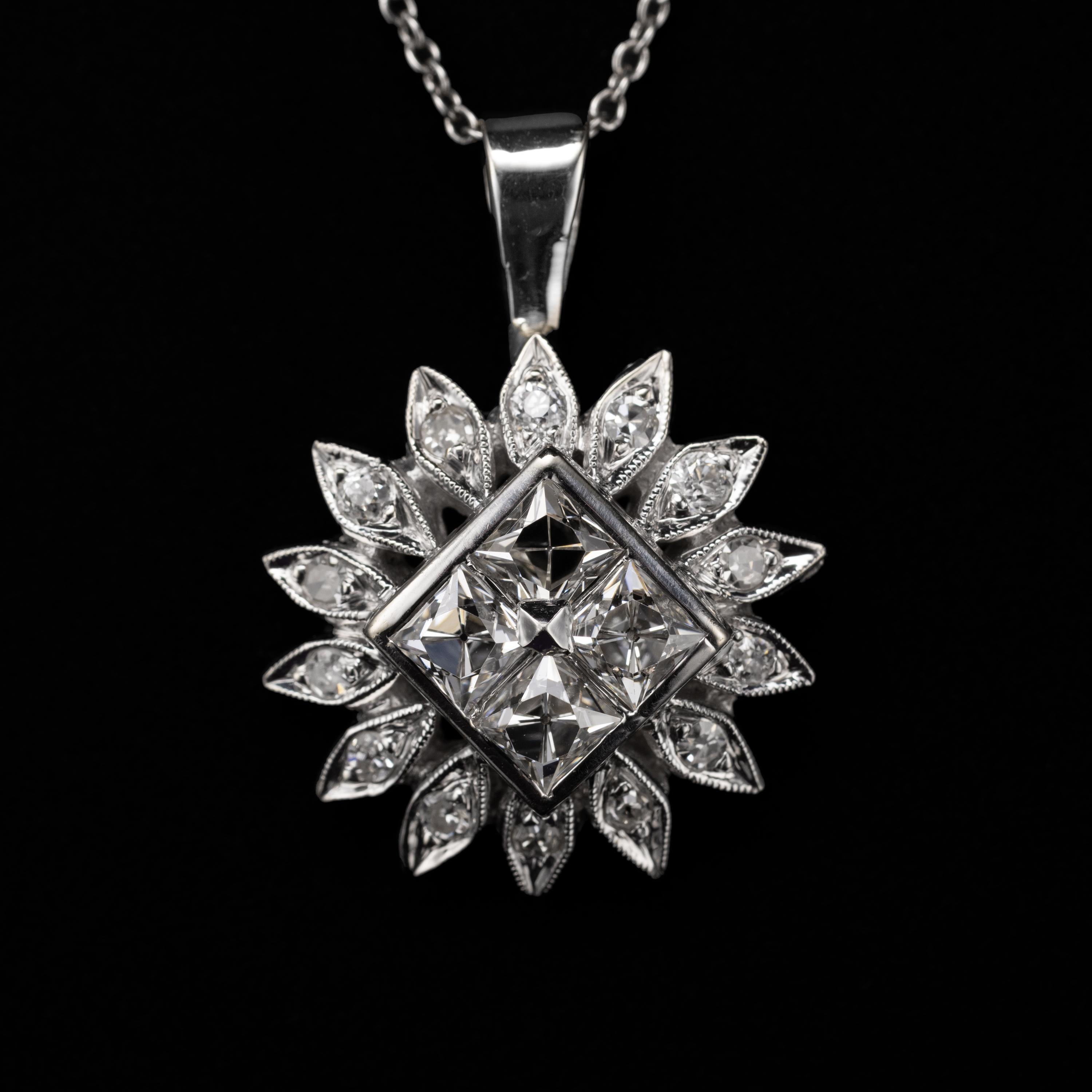 This is a stunning and uncommon pendant featuring four French-cut diamonds set in a central frame aligned on the bias and surrounded by 