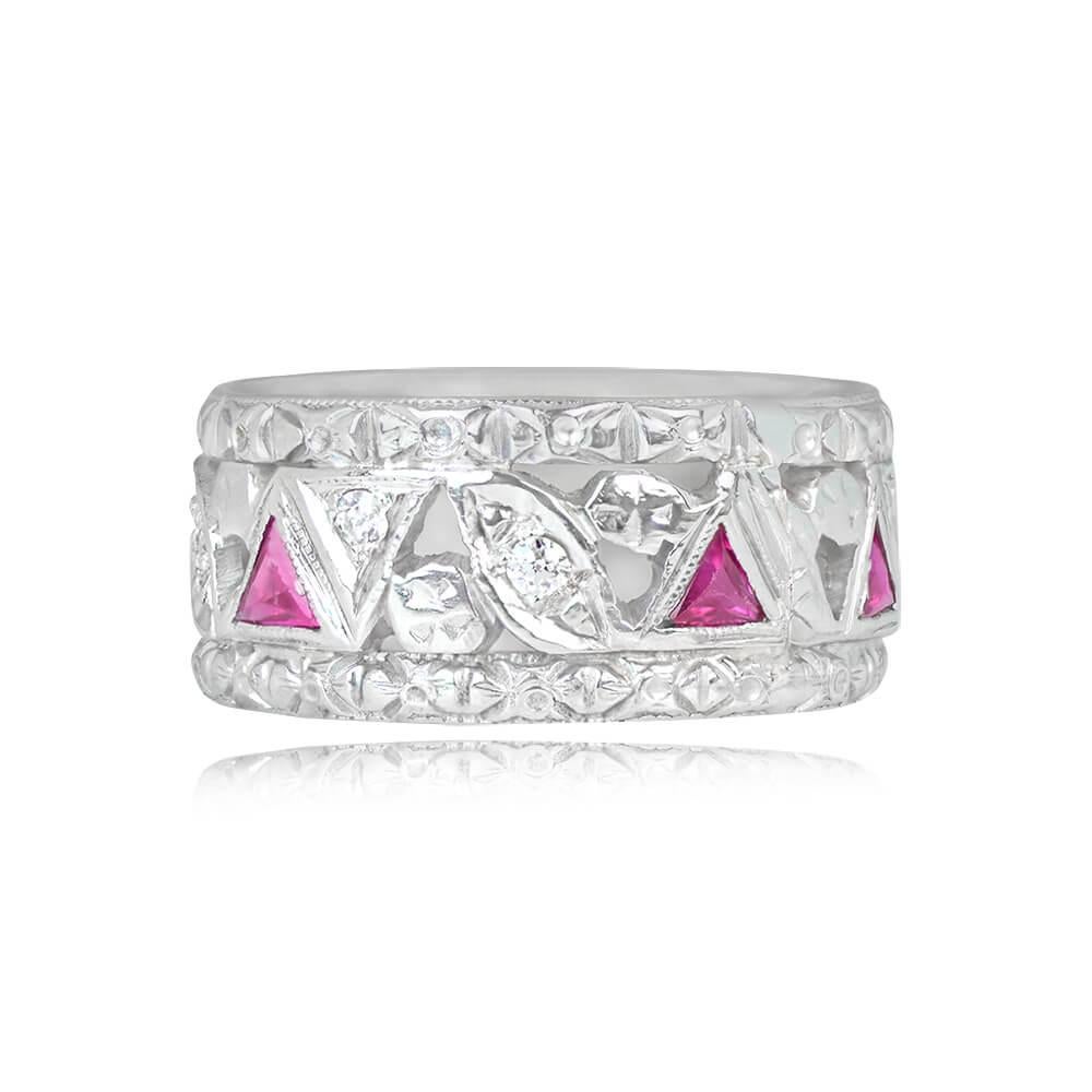 A late Art Deco wedding band showcasing triangular French cut rubies and old European cut diamonds in a platinum and white gold geometric design with hand engravings. The rubies weigh approximately 0.25 carats in total, and the diamonds have a total
