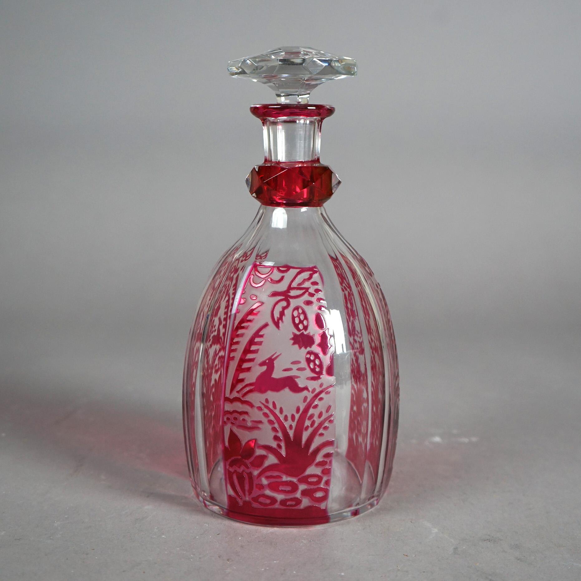 An antique French Daum Nancy decanter offers cranberry cut to clear art glass construction with leaping deep in forest setting, signed as photographed, c1920

Measures - 10