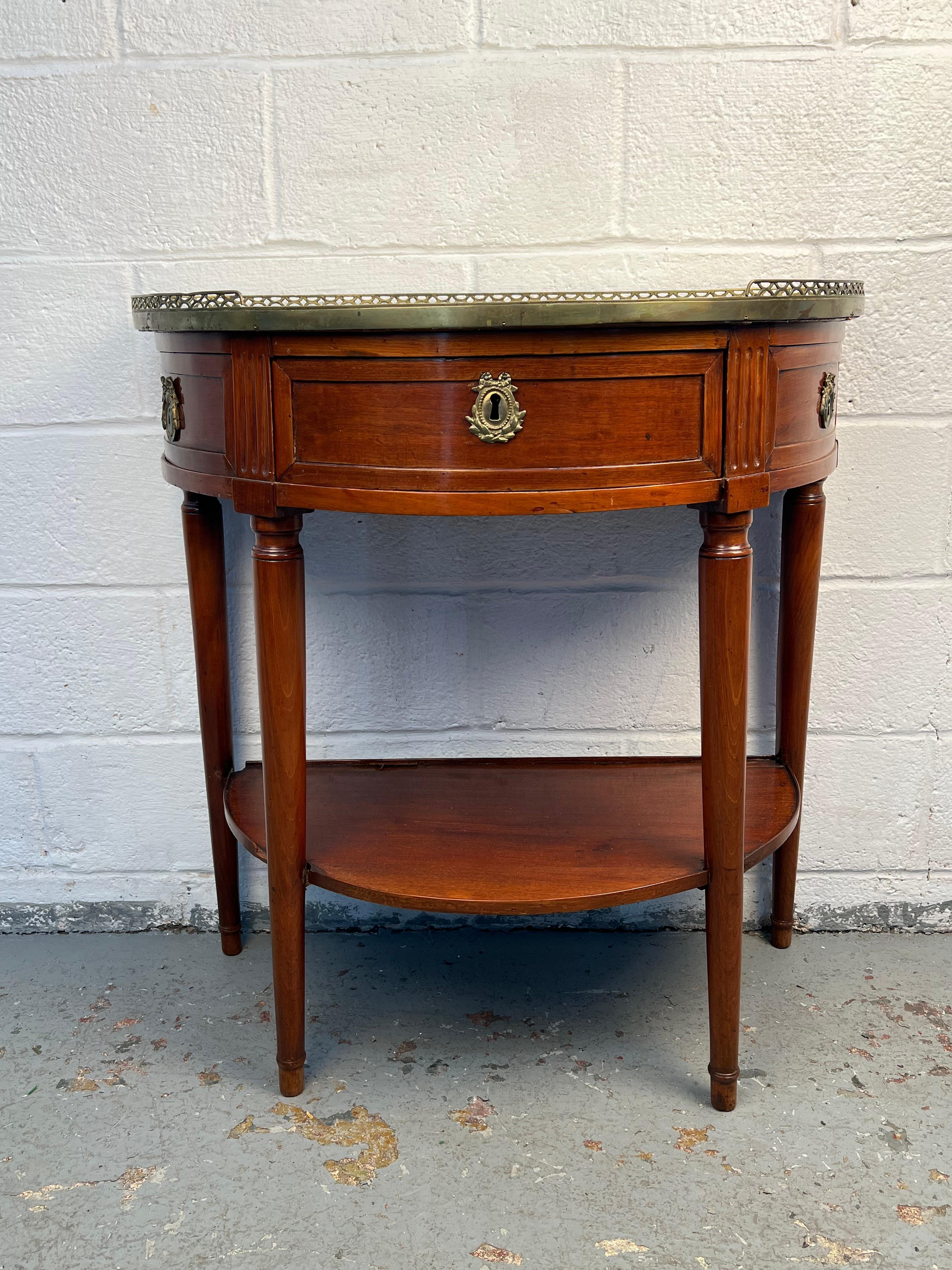 Elegant French demilune boutique table crafted in warm walnut, accented with refined brass trim and topped with marble. The graceful half-moon shape offers timeless appeal, while the combination of fine materials highlights both function and