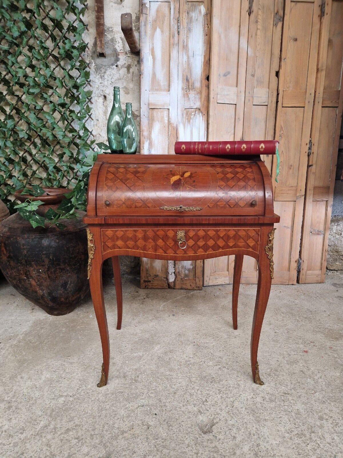 This fabulous Bureau de Dam Writing Desk, has a Cylinder Roll Top and has been designed in Louis XV Style.

The desk is dated late 19th Century and of French origin. The Bureau is Inlaid and veneered in various wood colours and styles, with a