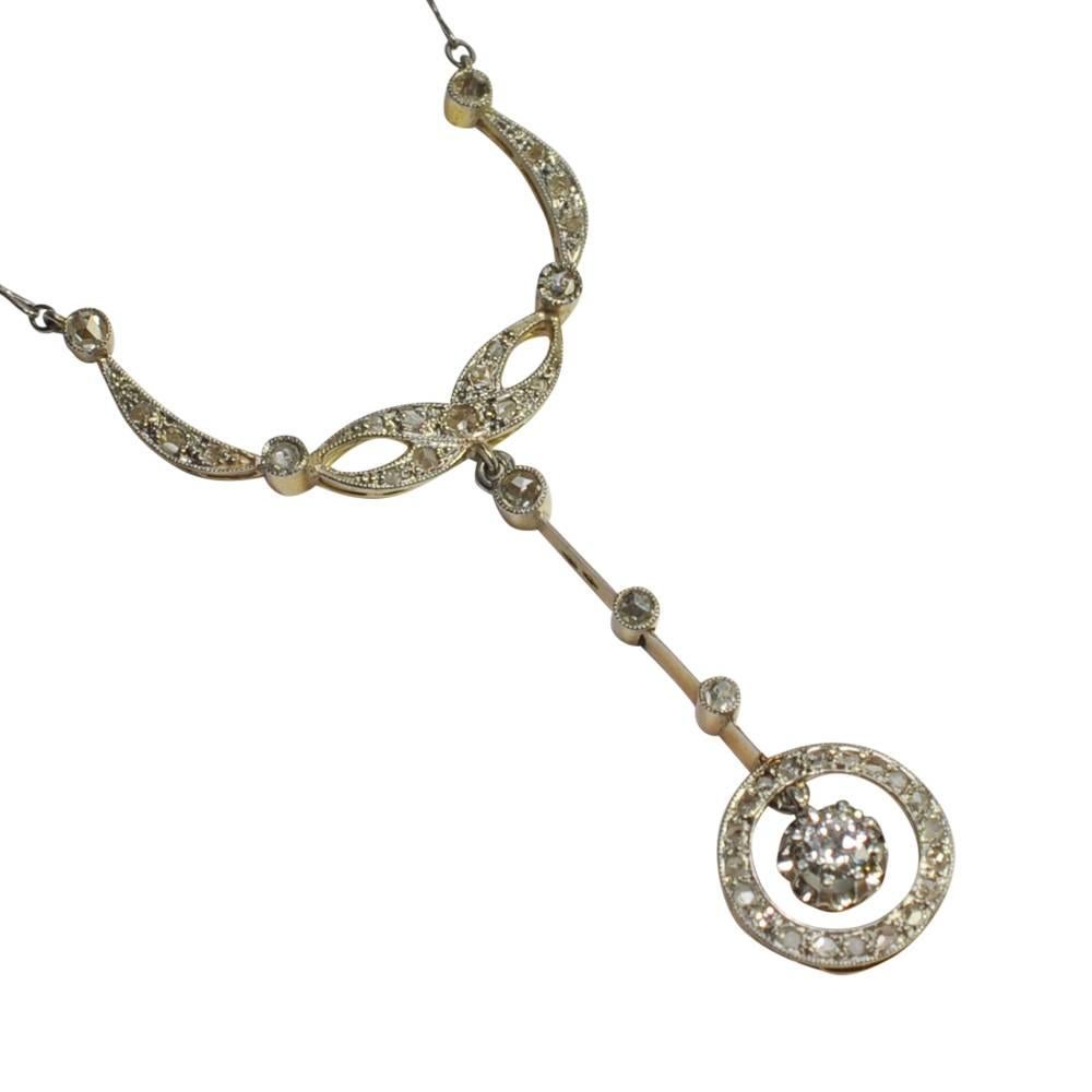 Antique French diamond 18ct gold and platinum necklace; this dates from the 1920s and is formed of a circle of rose cut diamonds with millegrain edging surrounding a transitional cut diamond solitaire weighing 0.18ct.  This, in turn,  is suspended