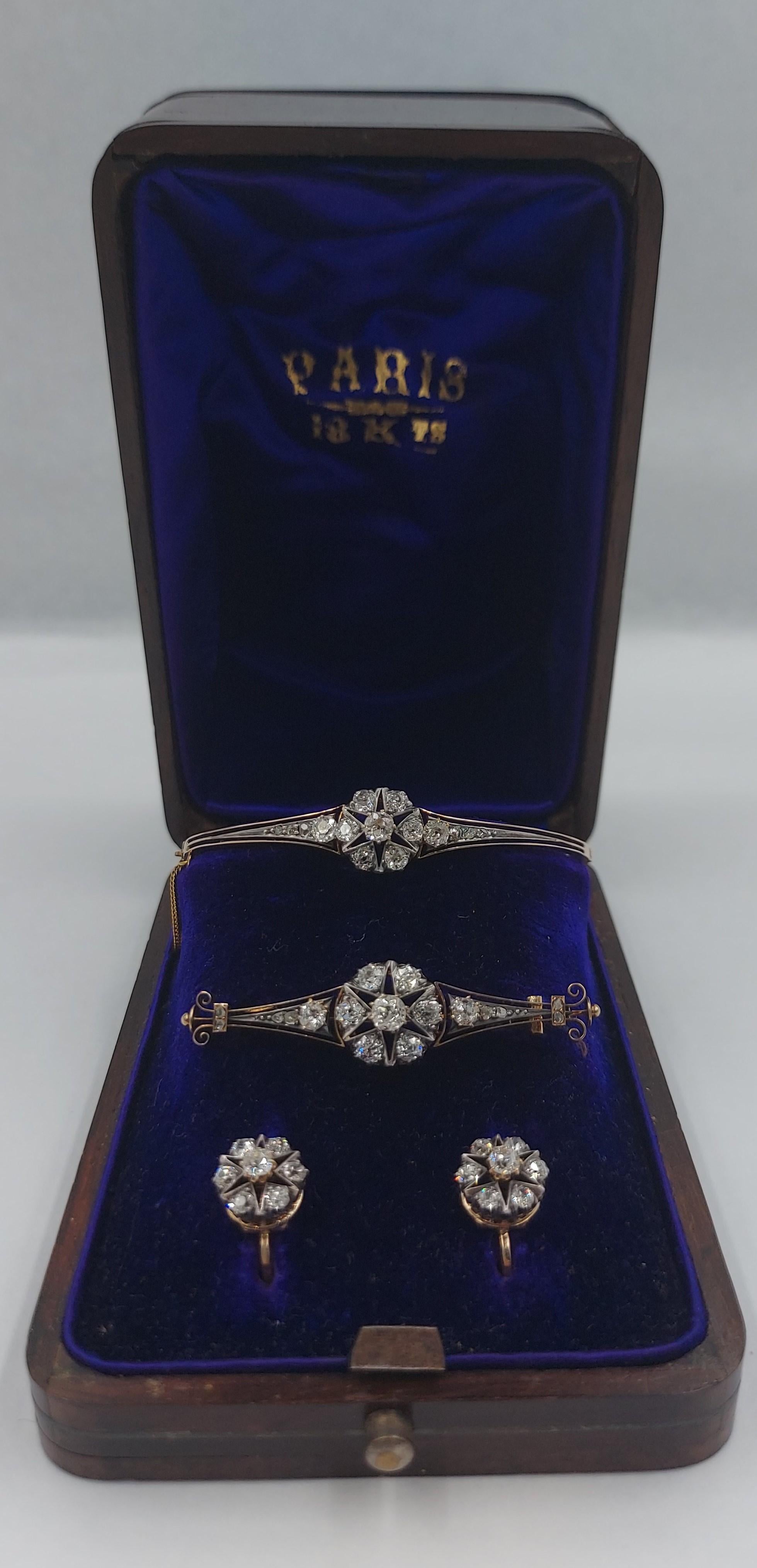 Antique, French, fine, elegant diamond parure. The set consists of bangle, brooch and earrings in original, fitted luxury box.  Circa 1890 typical stars design in 18 karats yellow gold  (signed 18)  with European cut diamonds (circa 5 carats) set in