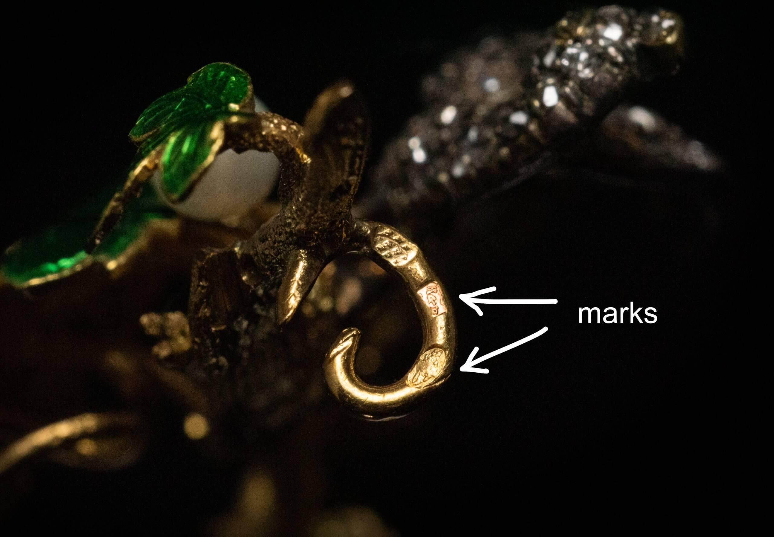 France, circa 1840 – 1850.  The brooch is superbly modeled as a silver and gold bird embellished with old rose cut diamonds standing on a gold branch with four guilloche enamel leaves and a pearl. The branch is textured to imitate natural wood. 