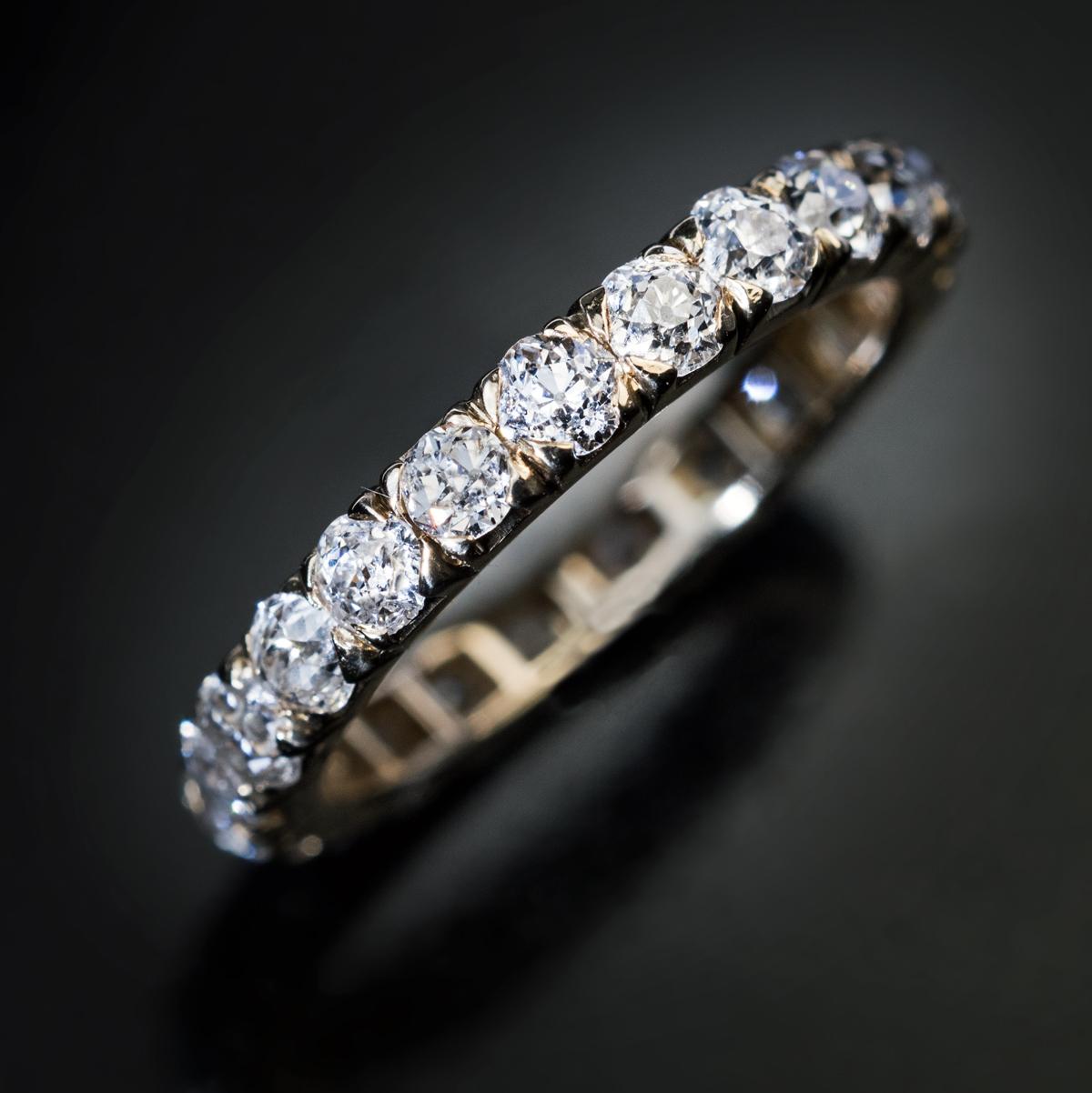 France, circa 1900.

This rare antique eternity band is handcrafted in 18K yellow gold and set with bright white chunky old European and old cushion cut diamonds (mostly F-G color, SI clarity).

Estimated total diamond weight is 2.30 ct.

The ring