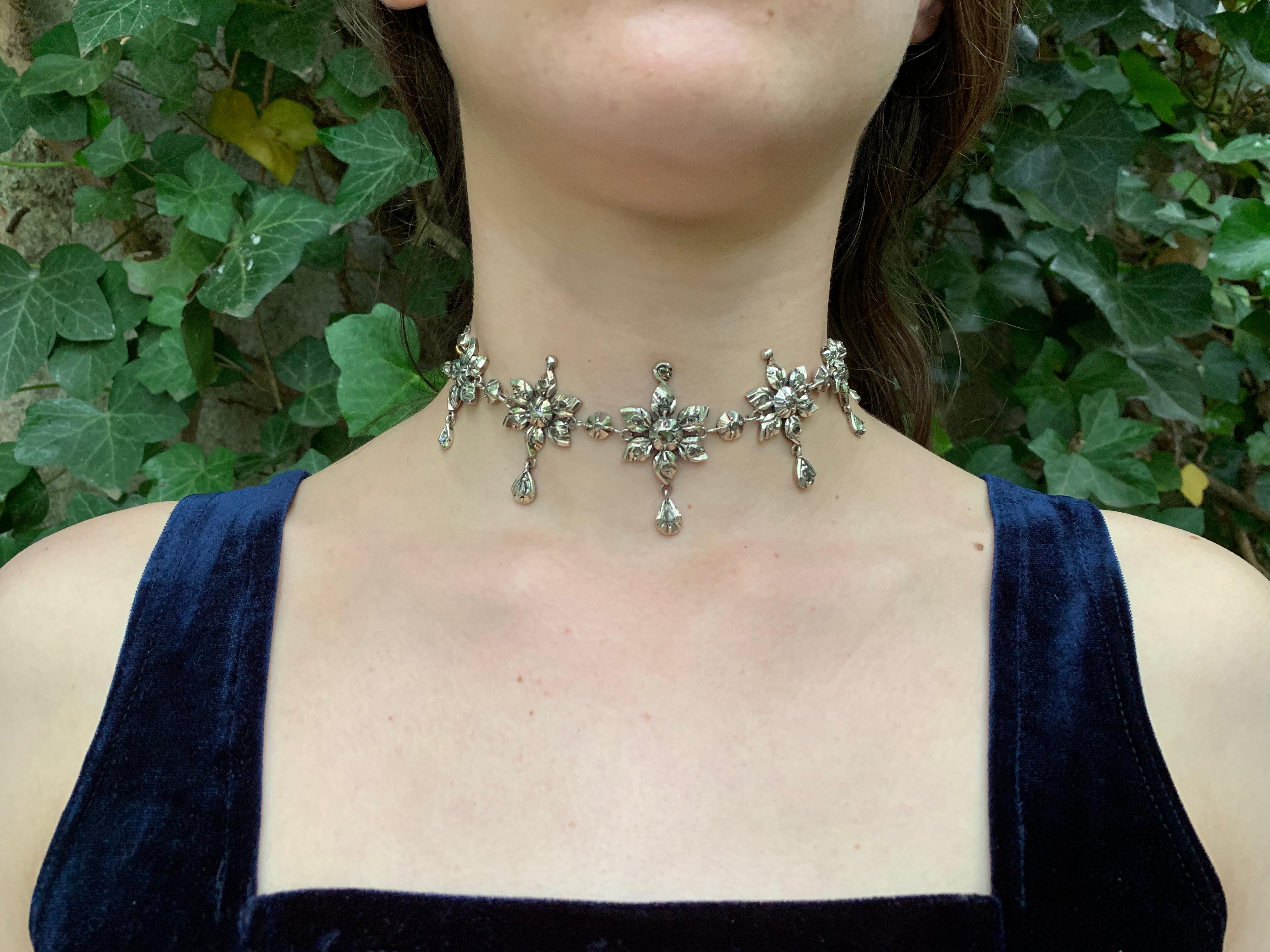 This rare French 18th century silver and rose diamond choker was handcrafted in 1770 ca and comes from Provence or neighbouring departements. This lovely piece of jewellery is designed as a succession of  seven diamond set flowers.  Each flower has