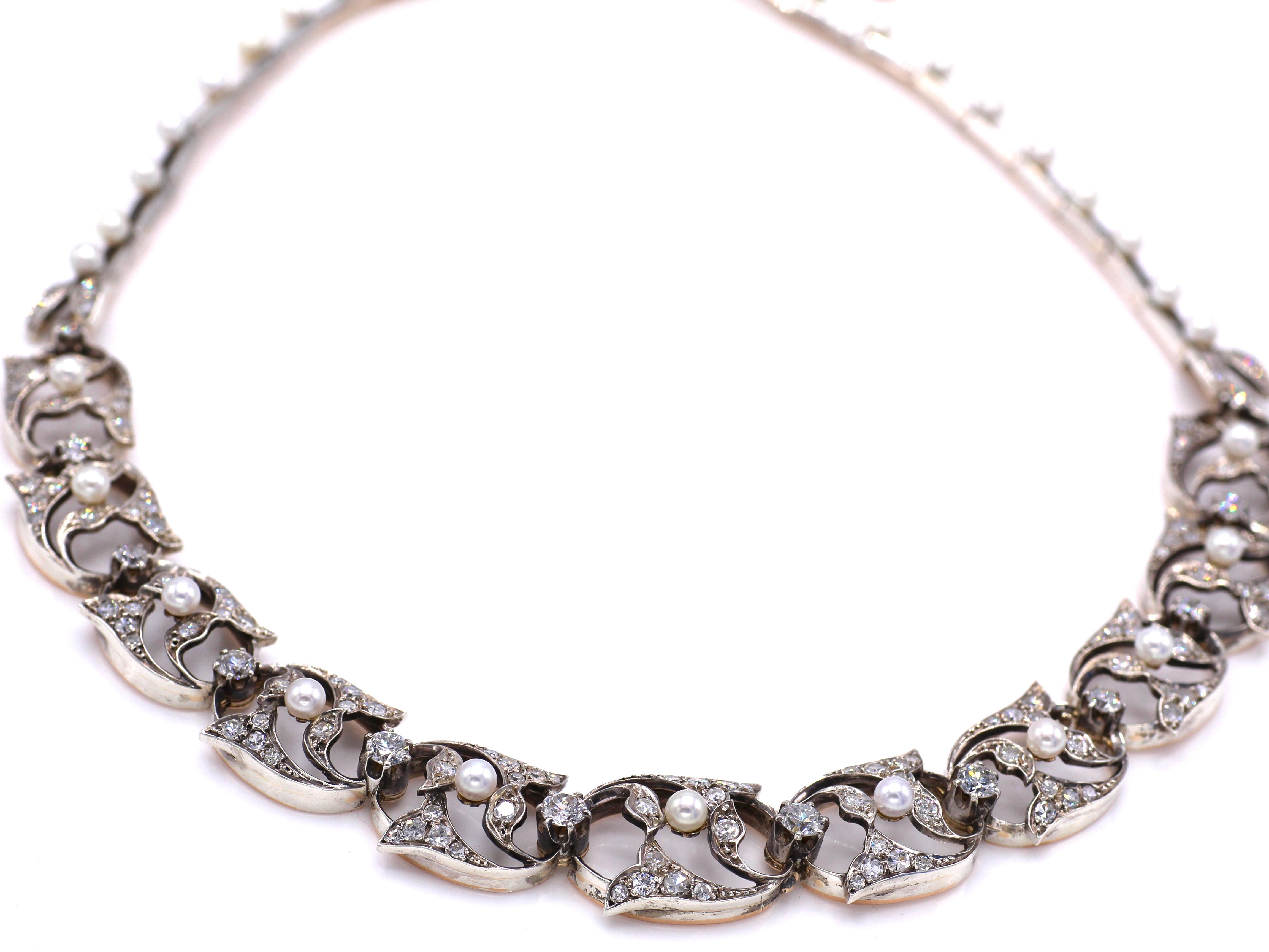 Beautifully designed and masterfully handcrafted in silver topped 18 karat gold, this French antique necklace from ca 1870 is a unique piece of period jewelry. Set with 21 perfectly matched white and lustrous pearls and embellished with bright white