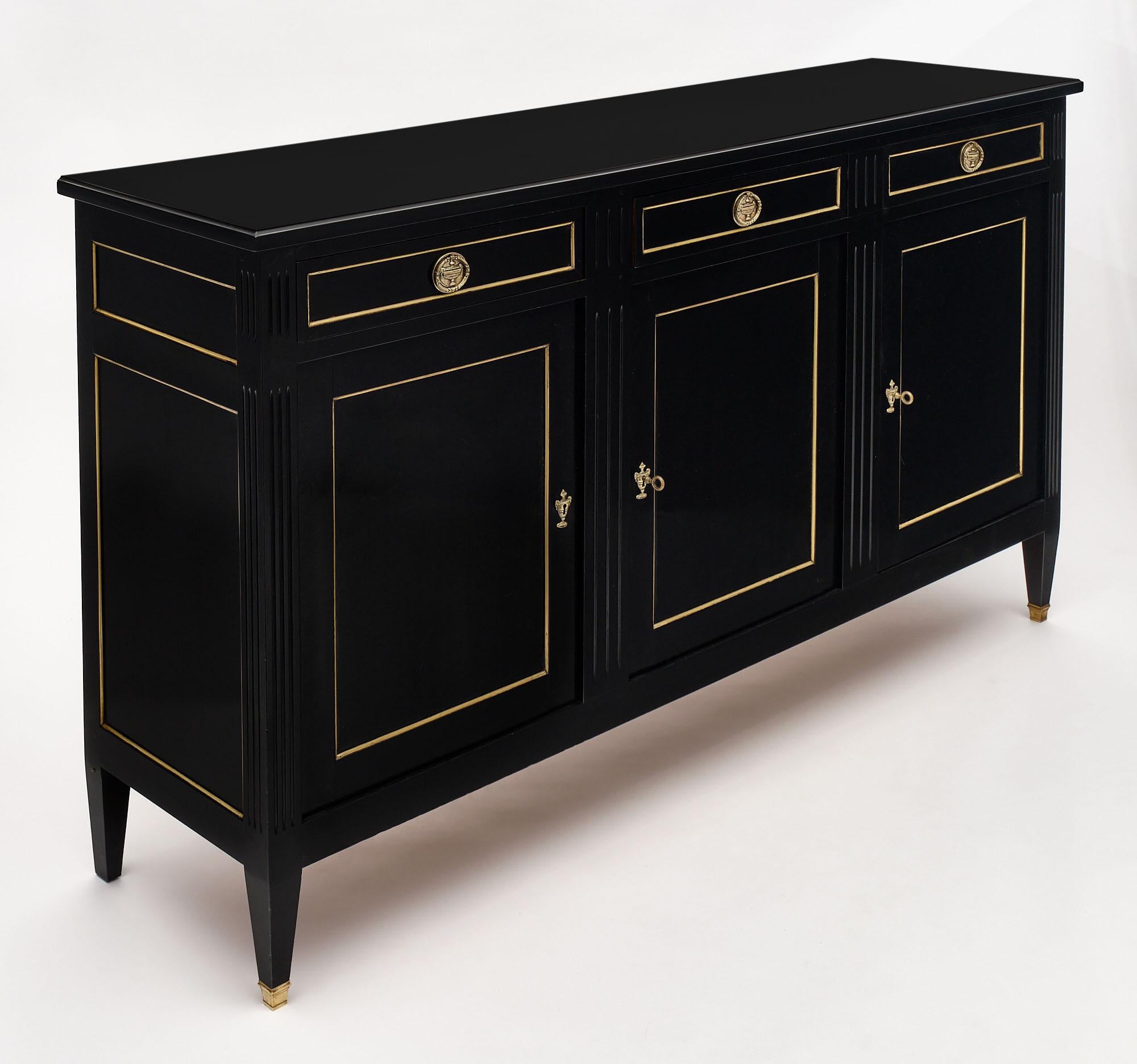 Antique French Directoire buffet from a restaurant in the Rhone Valley. The buffet is in great condition and made of solid walnut that has been ebonized and finished with a French polish. We love the gilt brass trim and hardware; as well as bronze