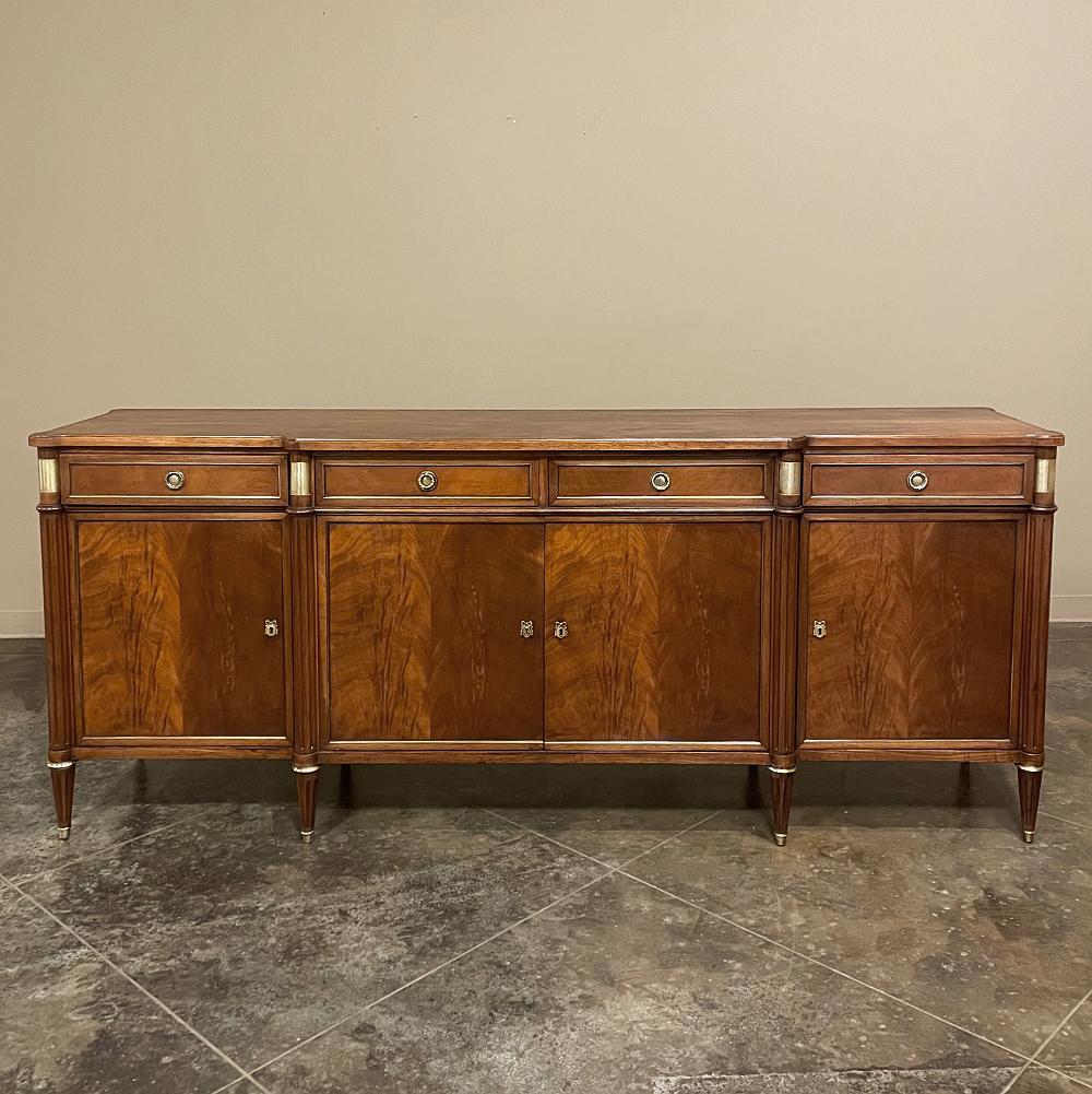 Antique French Directoire Mahogany buffet represents the essence of understated elegance! Tailored, rectilinear lines define the architecture, with a step-front center section defined by three-quarter rounded and fluted cornerposts, repeated on the