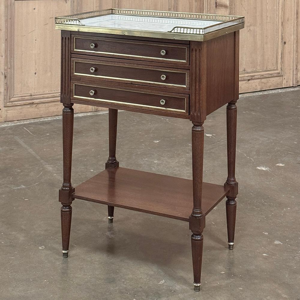 Antique French Directoire Mahogany End Table with Carrara Marble will make a delightful addition to your room, providing storage, display, perhaps a place for a lamp, convenient drawers, and tailored elegance that is truly timeless, all in one