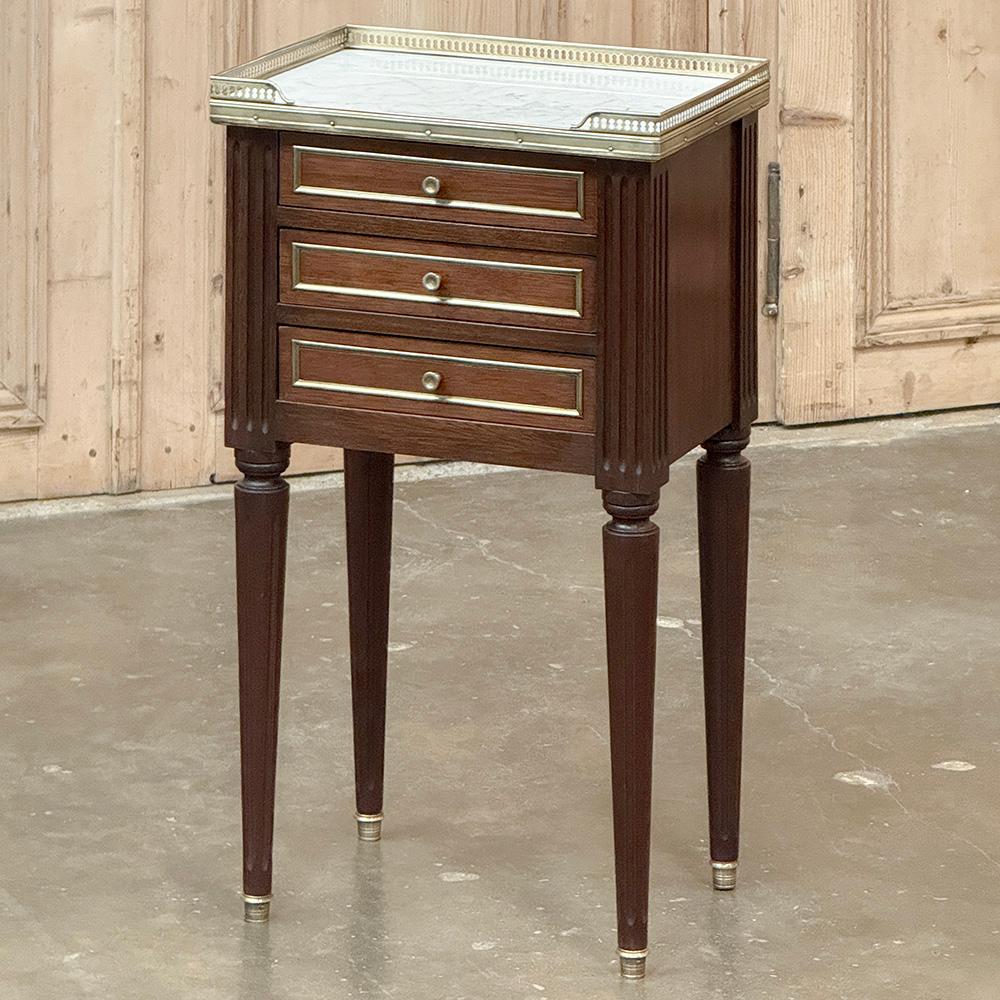 Antique French Directoire Neoclassical End Table with Carrara Marble will make the perfect addition to any room.  Hand-crafted from exotic imported mahogany, it has been given a finish on all four sides making placement in the middle of the room an