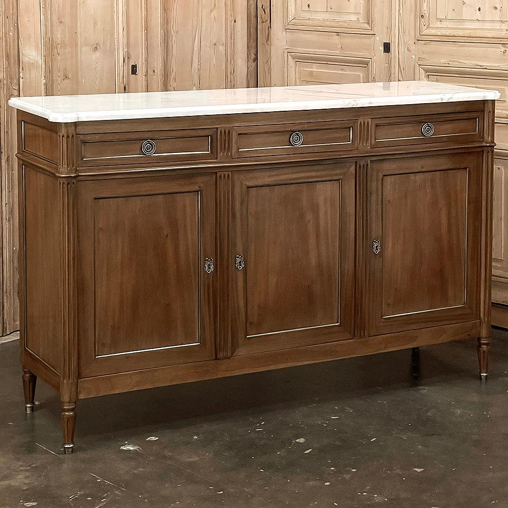 Antique French Directoire Neoclassical Mahogany Buffet with Carrara Marble Top combines classical architecture inspired by the ancient Greeks and Romans with exotic materials like imported mahogany and Carrara marble with inimitable French flair for