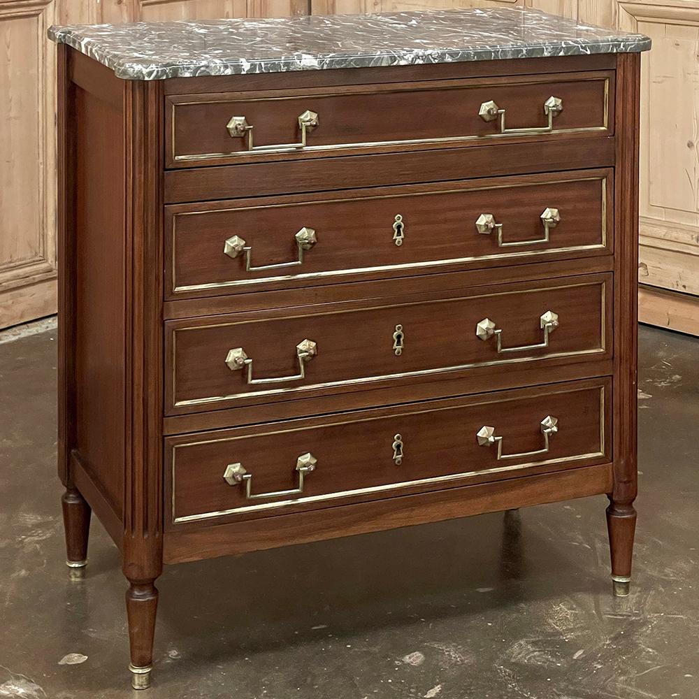 Antique French Directoire Neoclassical Mahogany Commode with Marble Top represents a revival of the classic style revived in this form at the end of the 18th century!  Crafted from fine imported mahogany, it features four full width drawers