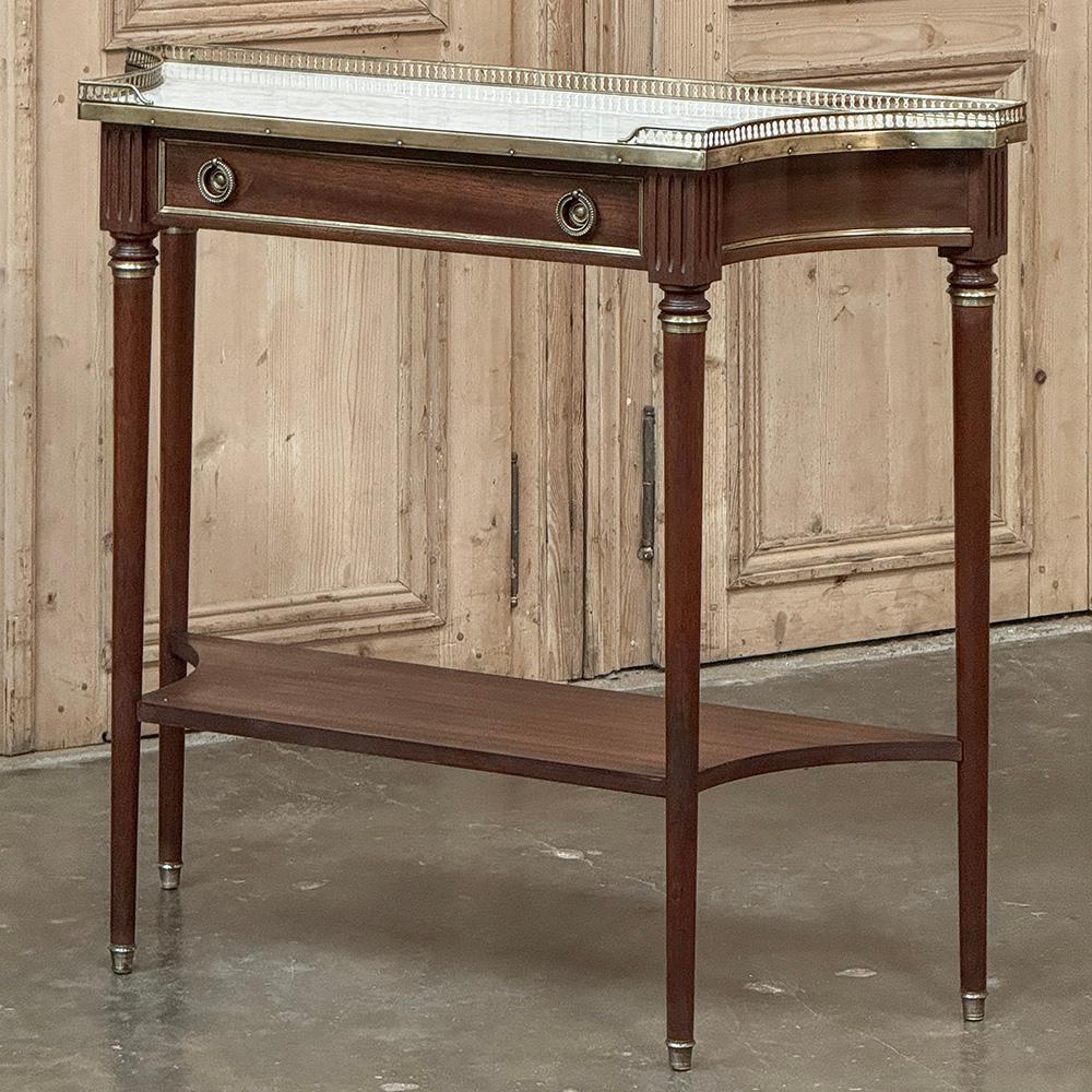 Antique French Directoire Neoclassical Mahogany Console with Carrara Marble is ideal for the efficient floorplan, or for adding a nice finishing touch to any room, including hallways, stairwell landings and entryways.  Only 14 inches deep, its