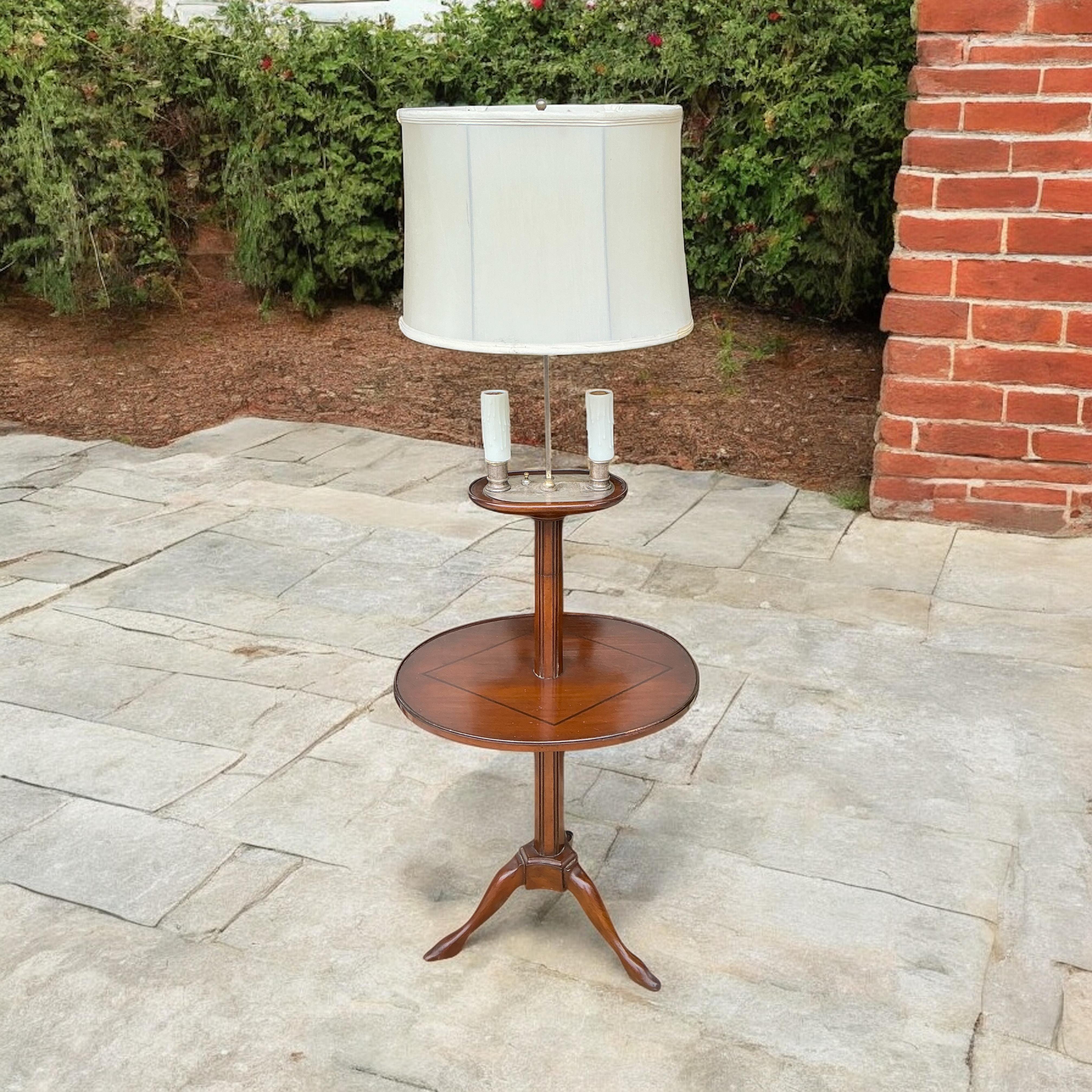 This is an antique French Directoire style floor lamp with side table. The wiring is new. The shade is included. The metal stem is adjustable. It is carved mahogany and in very good condition. Perfect for that comfy reading chair!