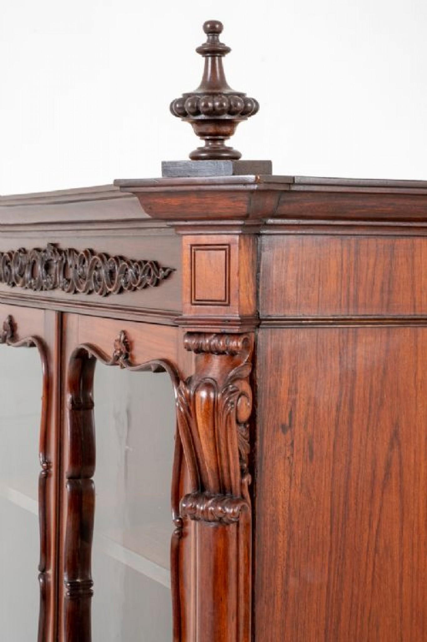 French mahogany display cabinet.
This 2 door cabinet standing upon carved feet with a carved and shaped apron.
The 2 doors featuring 4 glazed panels.
circa 1880
The doors being flanked by pilasters with carved corbels to the top and bottom, the