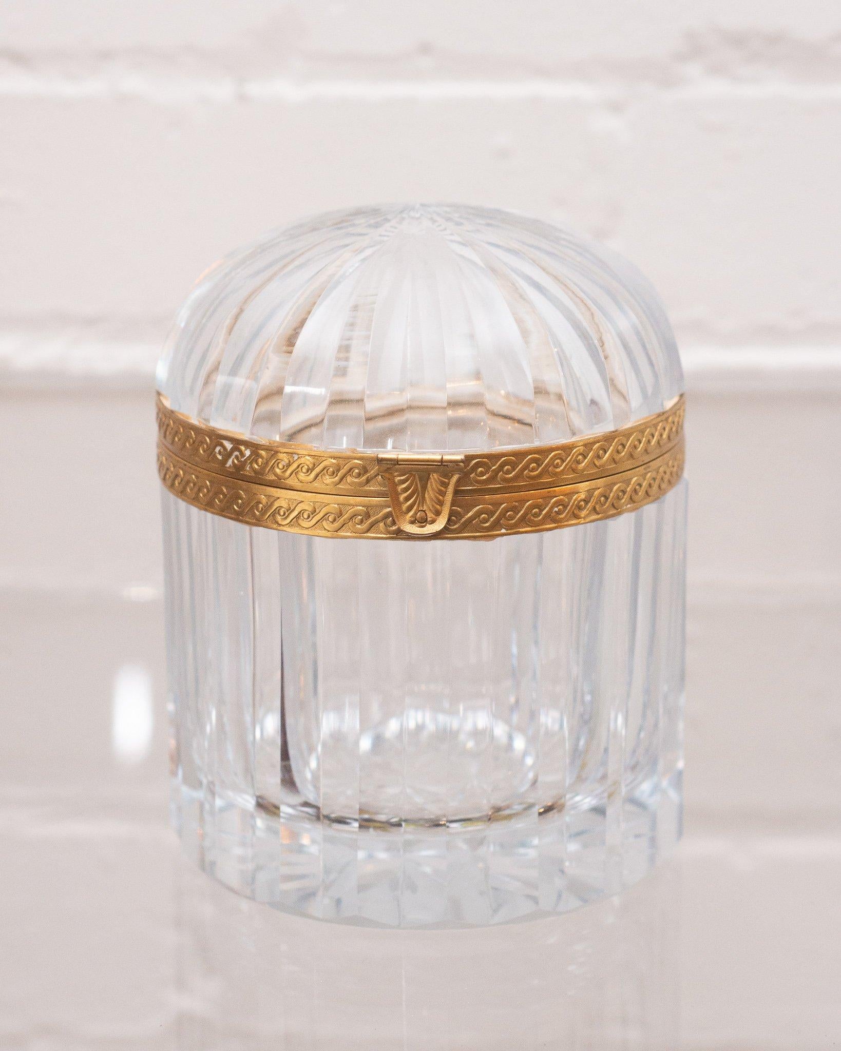 This antique French domed crystal and bronze box makes a statement in any space. An early 1900s production, this piece transitions from modern to Classic interiors seamlessly with its sophisticated shape and light catching quality.