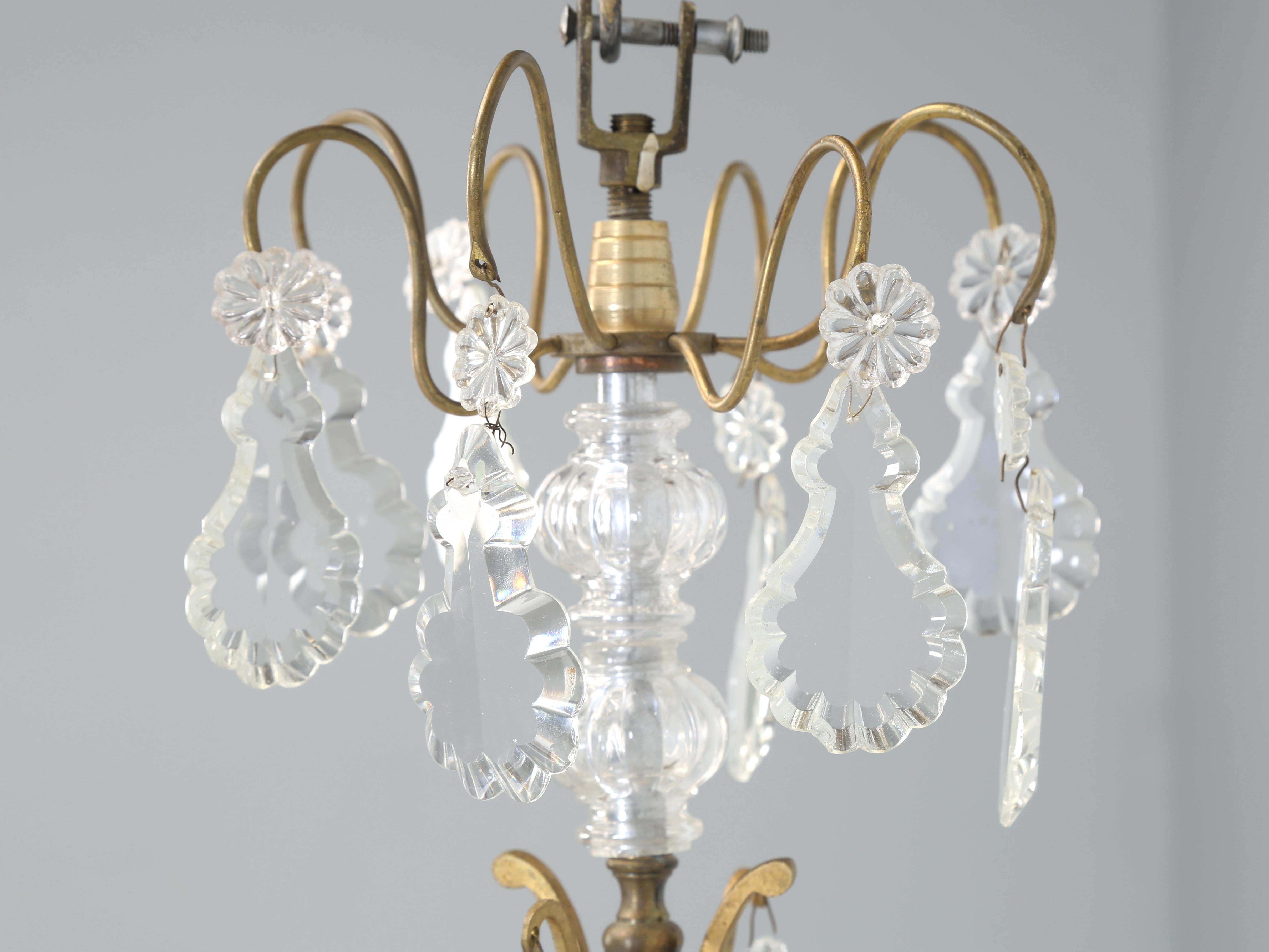 What at first looked to be your ordinary French Crystal Chandelier that no one bothered to wire for lightbulbs, turned out to be something quite special. Our first hint was the hand-blown sphere at the bottom of the Antique French Chandelier, which
