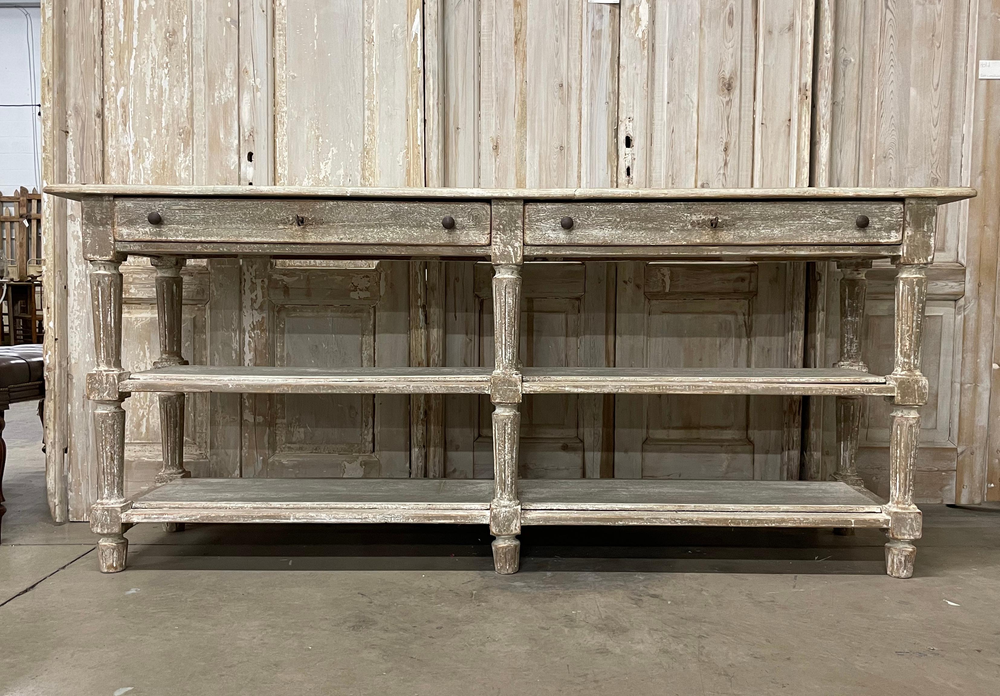 Rare antique scraped back draper's table from the Provence region of France.  It is very substantial with 2 long shelves below 2 drawers with its original keys.

It is a versatile piece of furniture and can be used in a number of design applications