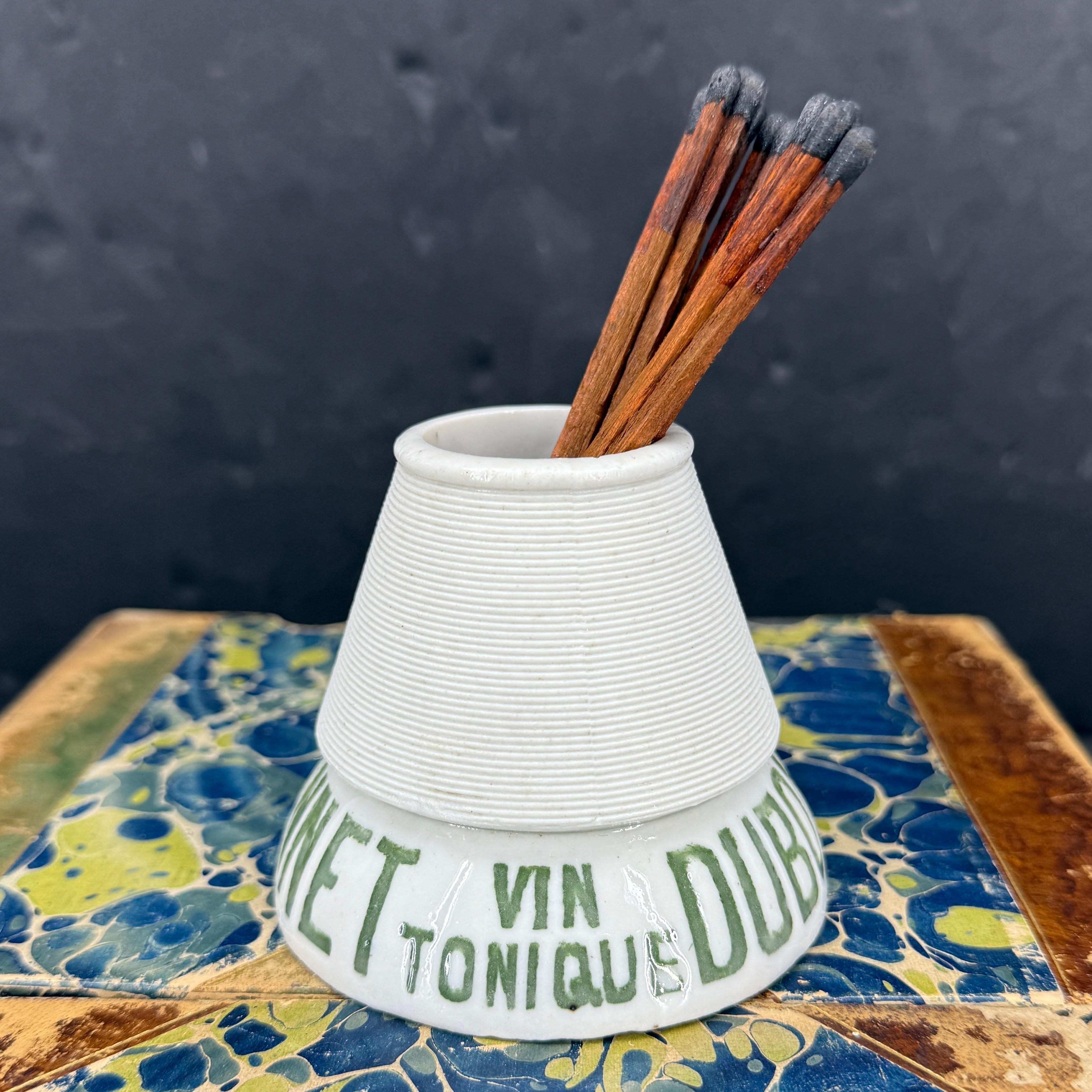 As found in at a French market, this classic green and white matchstick striker or 
