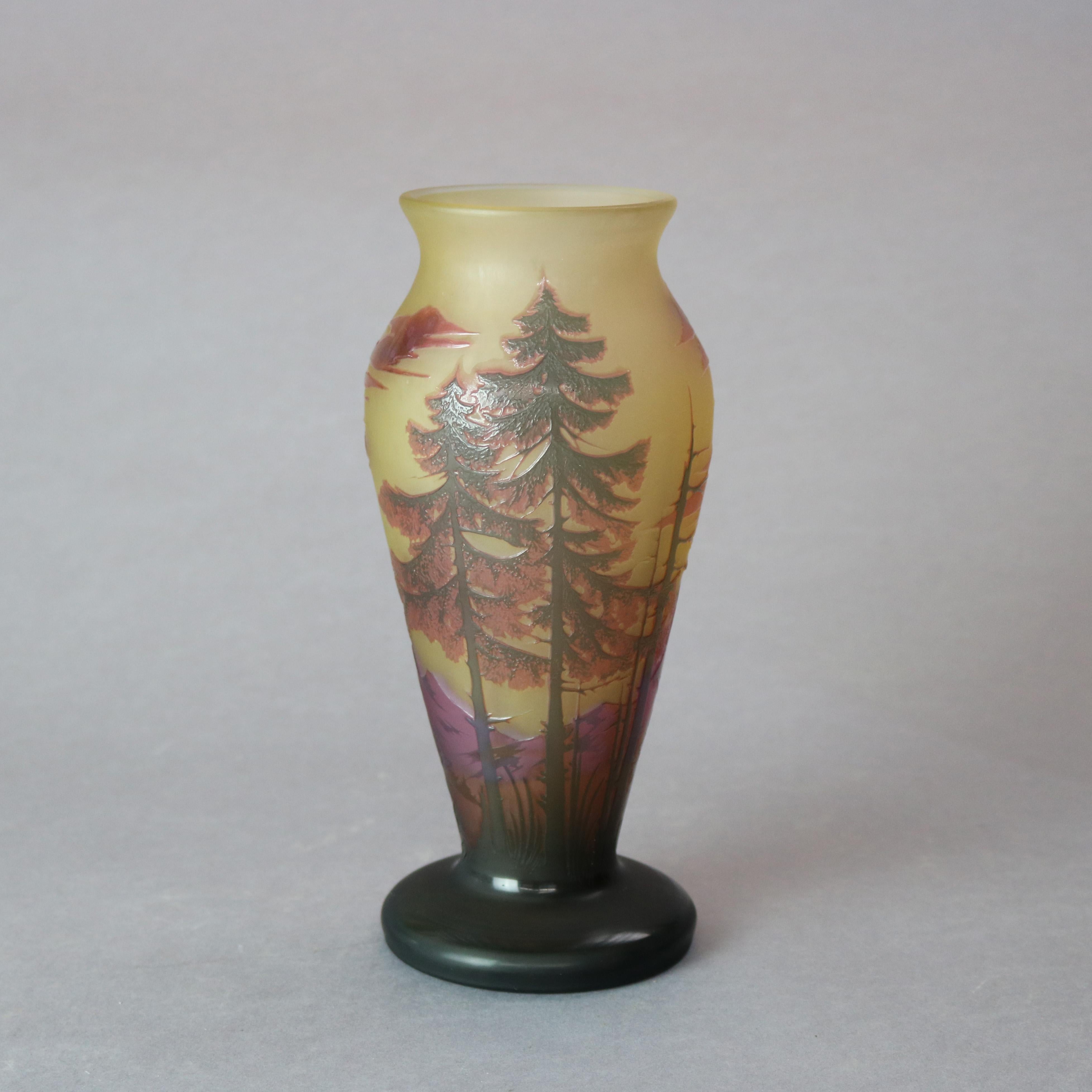 An antique French cameo vase by Dumochelle offers cut-back glass construction having landscape scene with pine trees, signed on base as photographed, circa 1900.

Measures: 9.75