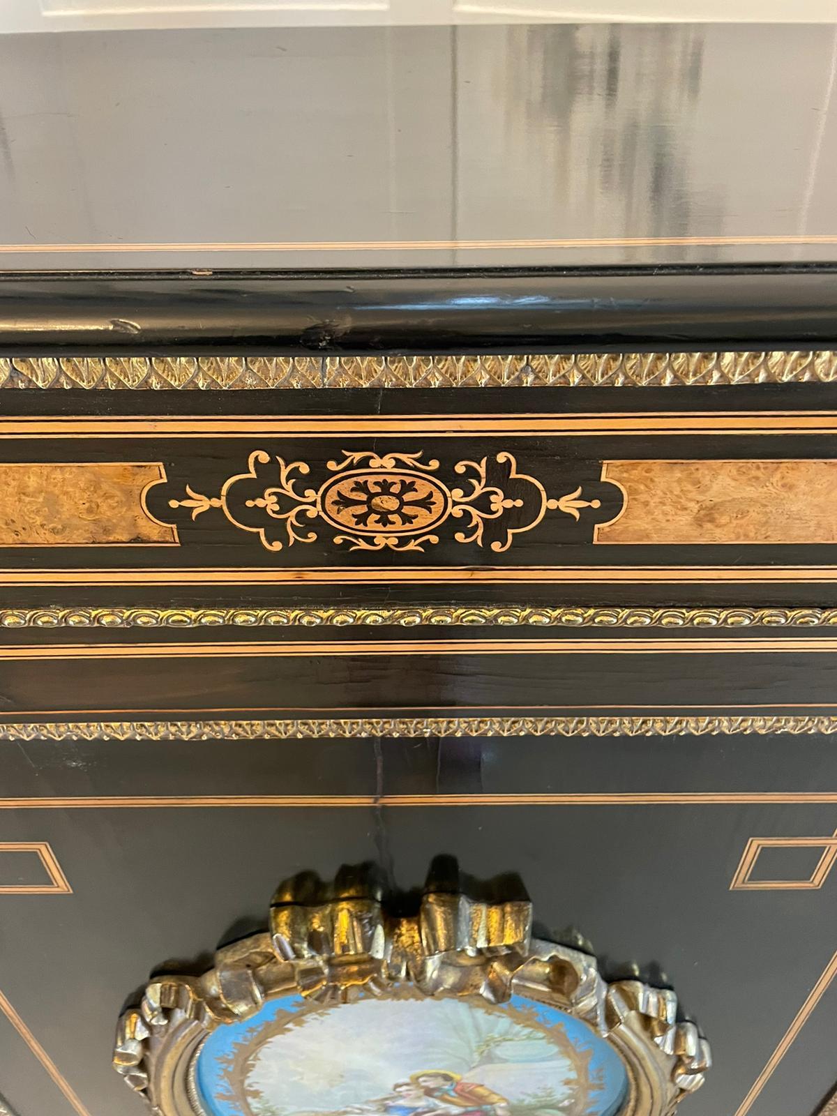 Antique French ebonized and amboyna credenza/sideboard boasting a wonderful large beautifully crafted sevres style plaque with ormolu mounts to the centre door. The shaped frieze inlaid with amboyna is delightful. Both bow doors are glazed and it