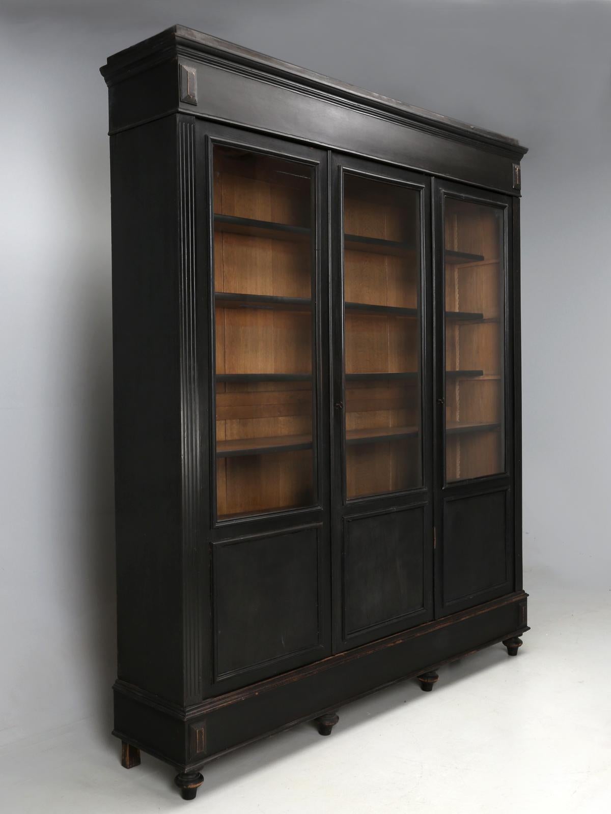 This is an unrestored, antique French bookcase, presented exactly how it looked in the late 1800s, when it was new. Typically, when we see a Napoleon III style black anything, more often than not, some antique dealer, like ourselves, will have