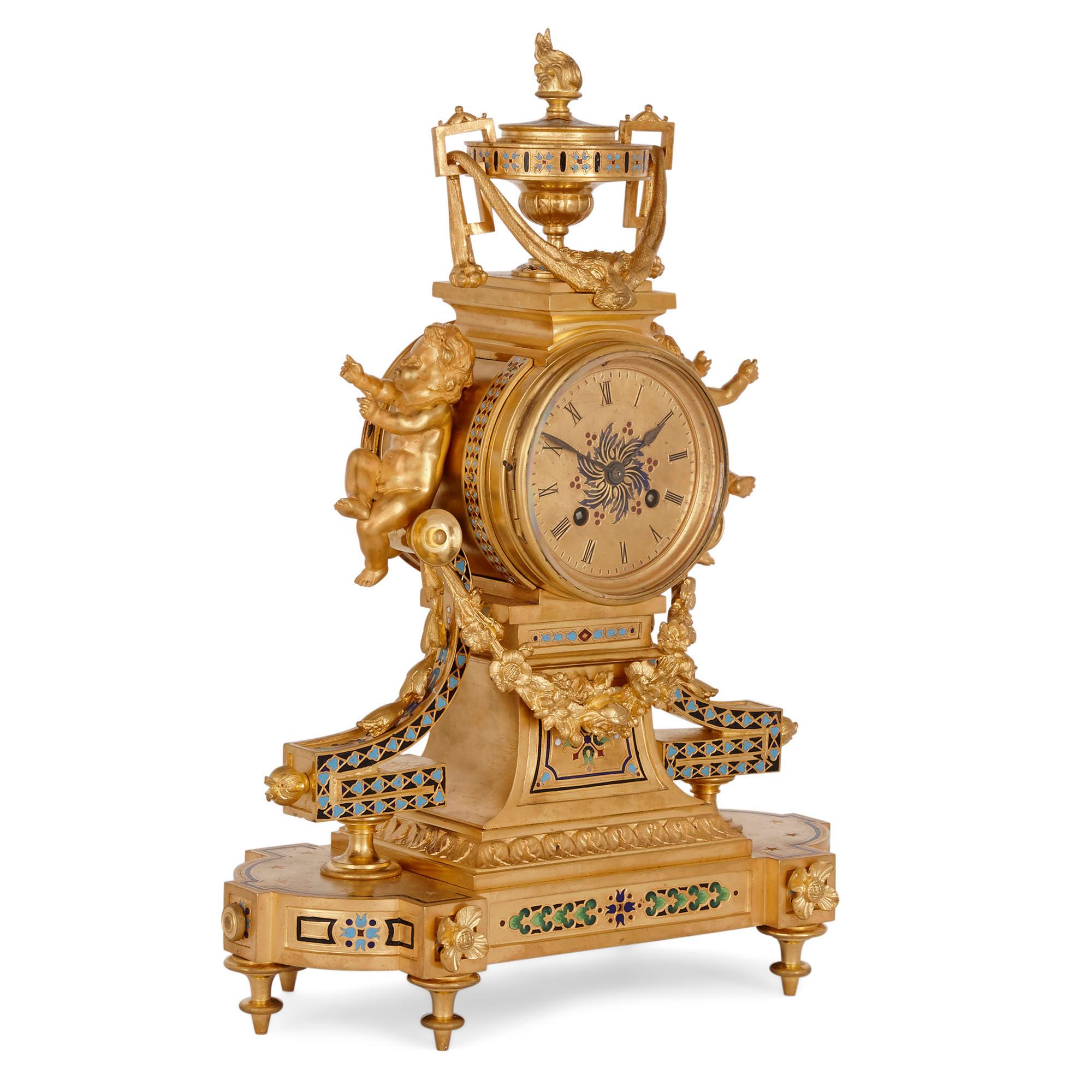 Antique French eclectic style enamel and gilt bronze clock set
French, late 19th century
Measures: Clock: Height 41cm, width 30cm, depth 15cm
Candelabra: Height 36cm, width 17cm, depth 17cm

This gilt bronze and enamel garniture contains a