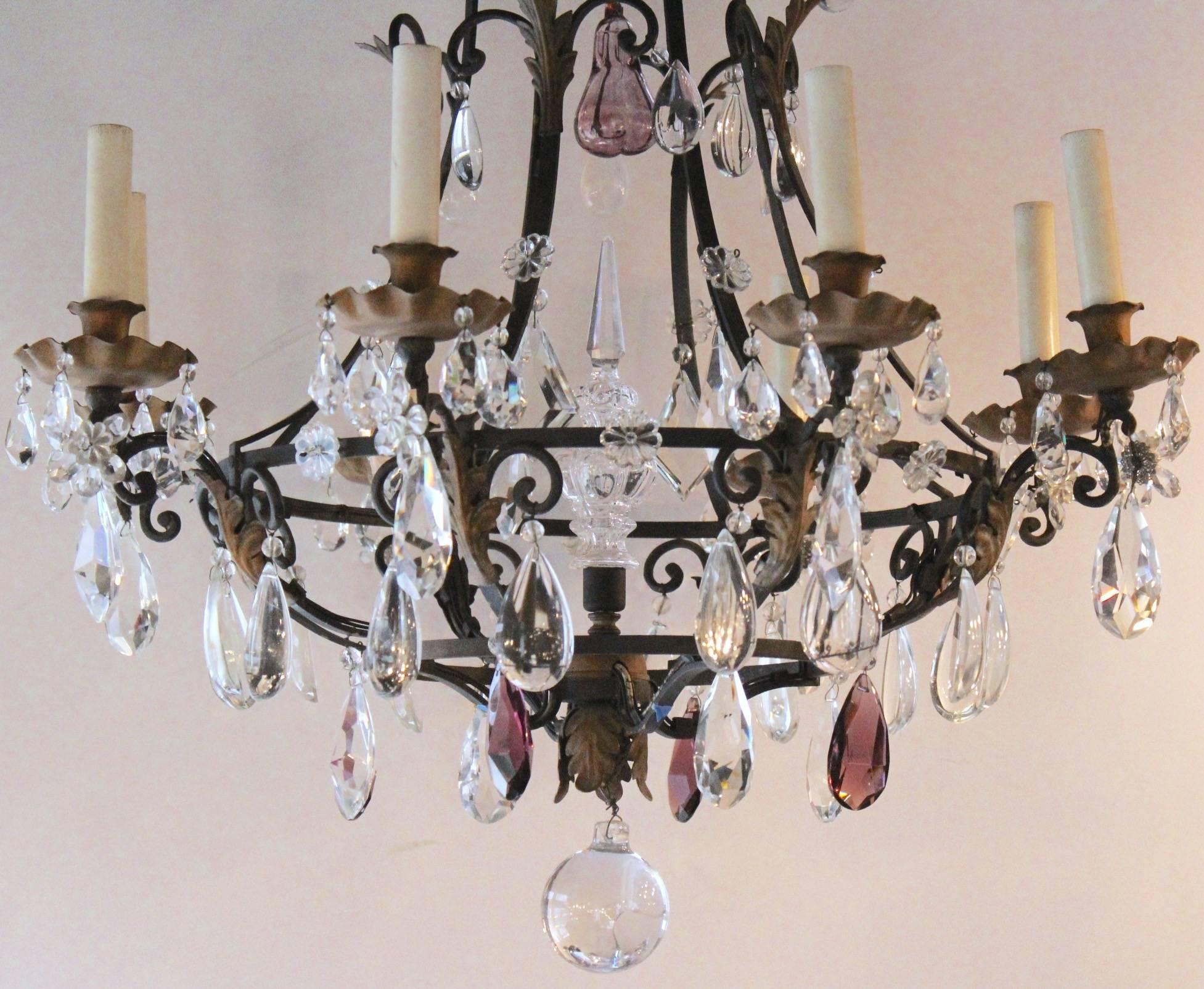 Very elegant  urn-shaped chandelier with painted and scrolling wrought iron arms terminated by brass bobeches.Magnificent decor of French crystal pendeloques as prisms,drops or pear shaped,some being in amethyst color.Great crystal 