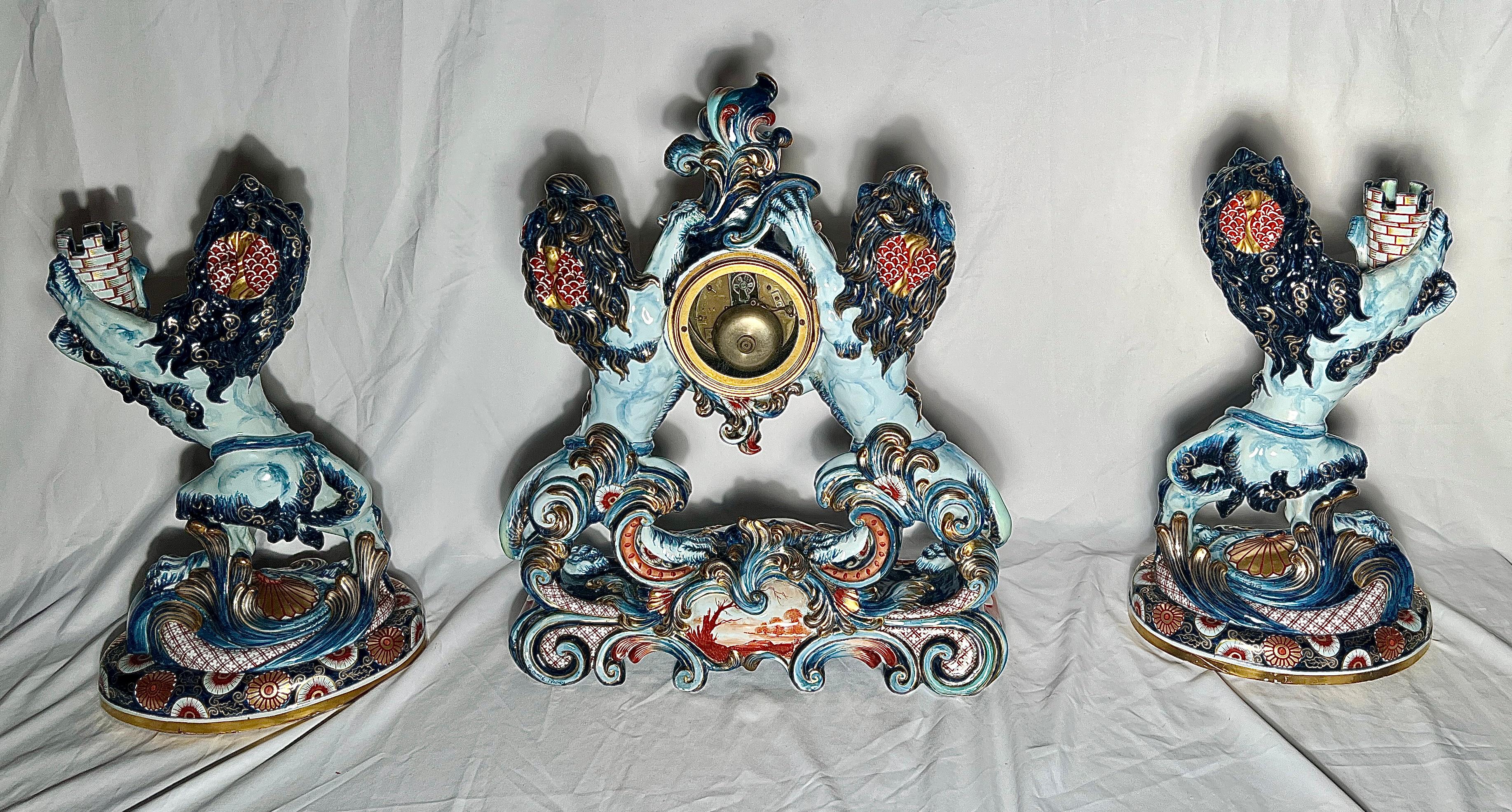 Antique French Original Émile Gallé 3 Piece Porcelain Lion Clock and Candelabra Garniture Set, Circa 1890.  Colors of Blue, Red, and White with Gold Details.  Signed by Art Nouveau Master, Émile Gallé.

Clock:  19 1/2