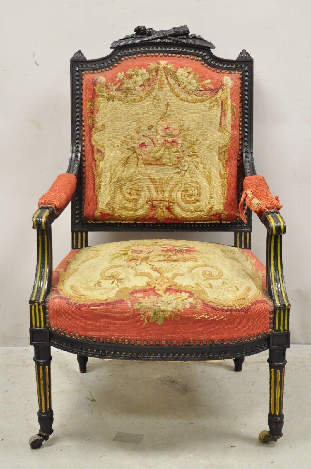 Antique French Empire Black Ebonized Walnut Needlepoint Parlor Arm Chair. Item features a coral floral needlepoint upholstery, torch and flame carved crust, gold painted finish, very nice antique item. Circa 19th Century. Measurements: 39.5