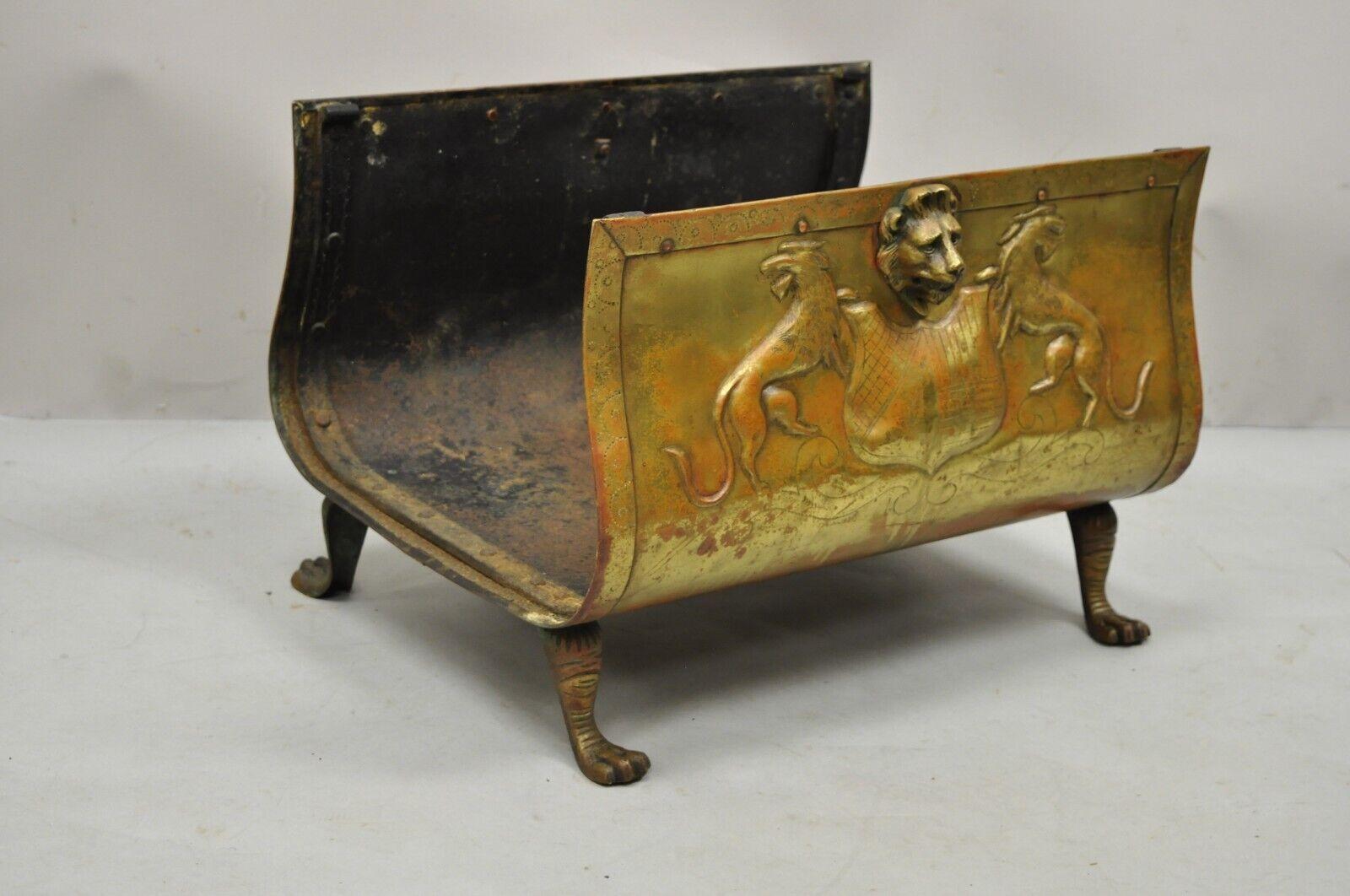 Antique French empire brass and cast iron fireplace log holder with shield lions. Item features debossed lions and shields, griffin figures, paw feet, desirable patina, very nice antique item, quality craftsmanship, great style and form. Circa 19th