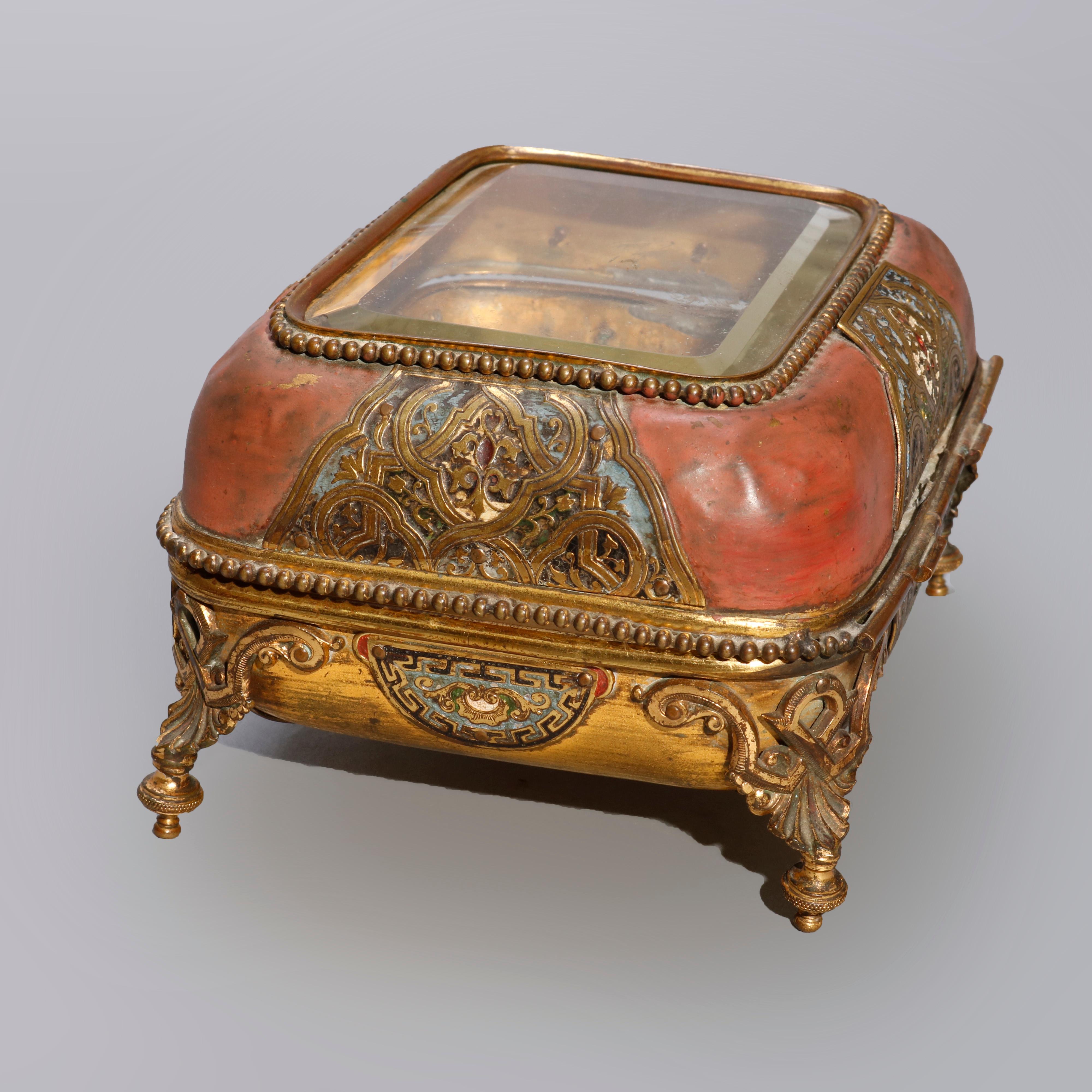 An antique French Empire dresser box offers bronze box with top having beveled glass viewing panel with beaded trim, box with Champleve enamel reserves of Moorish design, raised on acanthus form legs terminating in Marseille bun feet, interior