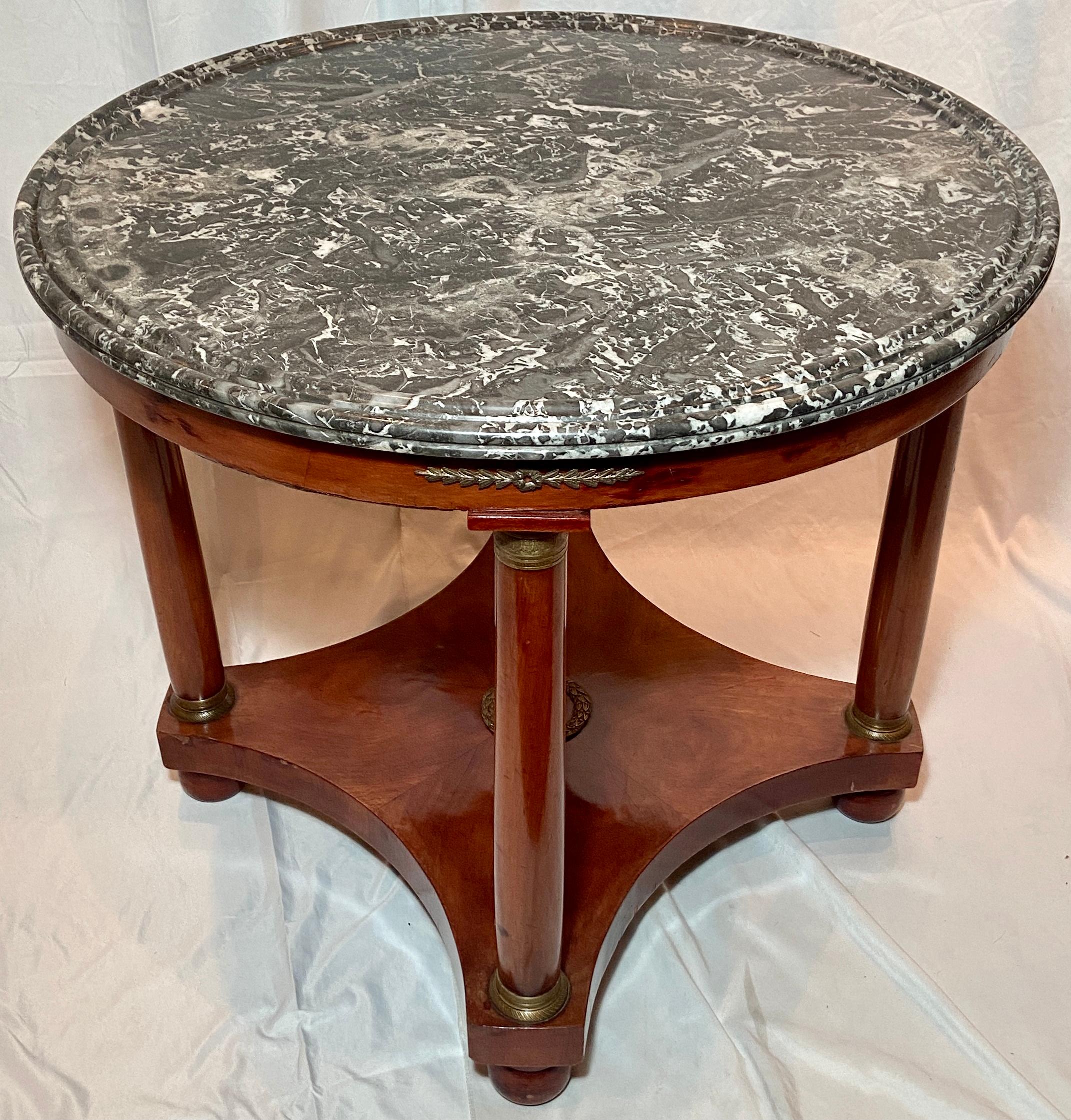 Antique French Empire bronze mounted marble-top mahogany center table Circa 1880.
A very handsome mahogany table with accompanying bronze decorative elements.