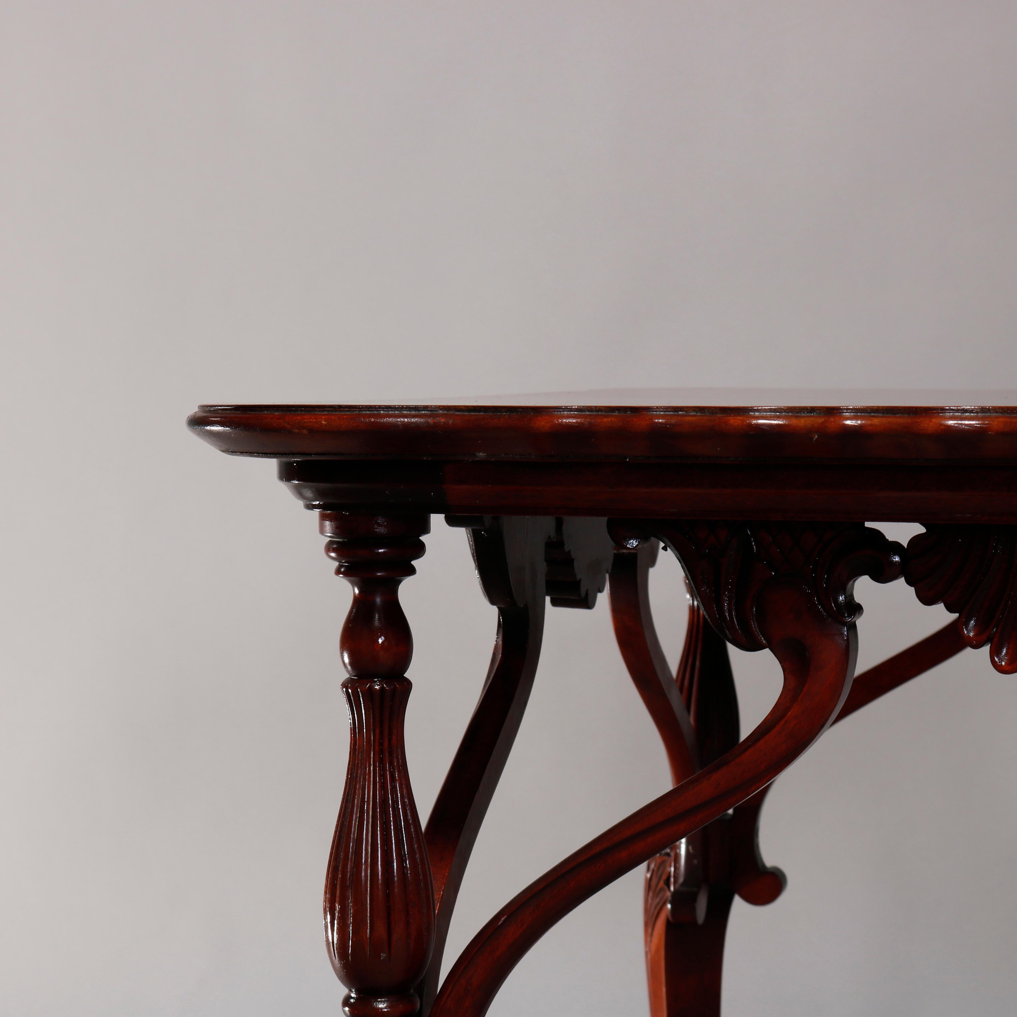 An antique French Empire lamp stand offers mahogany construction with shaped top surmounting base having scroll, shell and foliate elements, raised on cabriole legs, 19th century.

Measures: 28.5